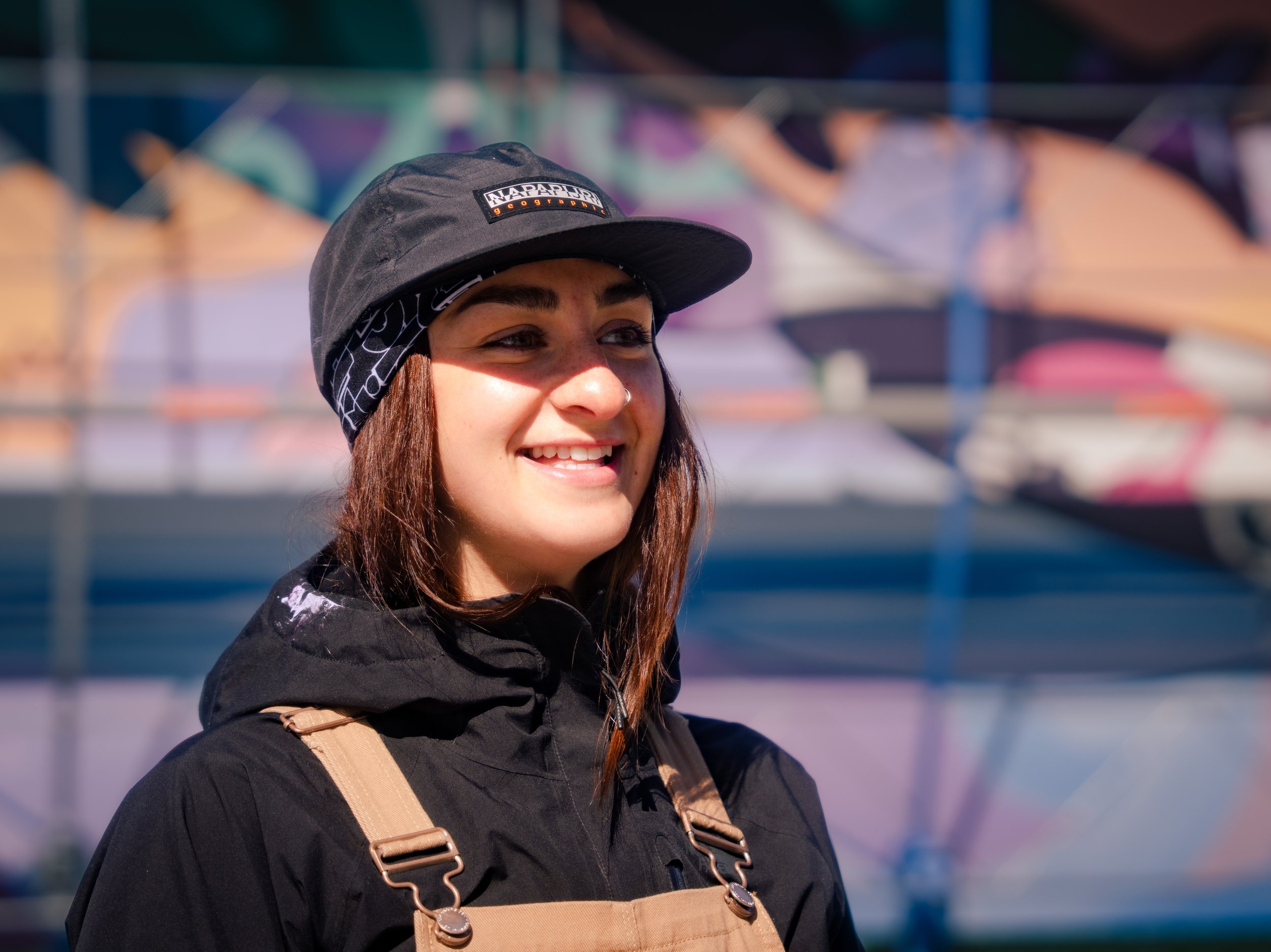  Ilinniaqtuit alumni, Jessica Winters at the Nunatta Atuagaateqarfia mural during the Nuuk Nordic Festival. Nuuk, Greenland. May 2023. Photograph by Bronson Jacque. 