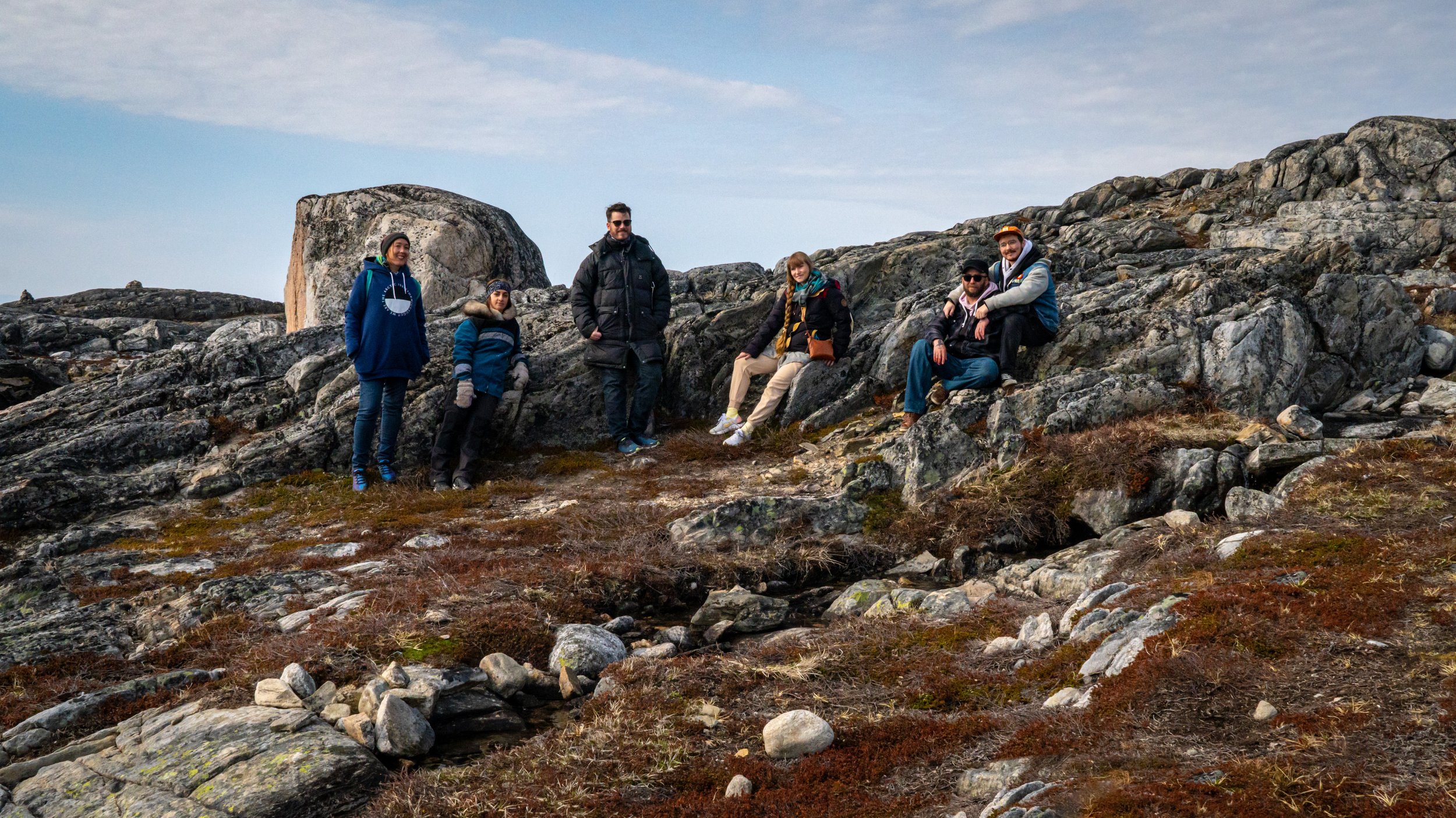  Iniut Futures  ilinniaqtuit and alumni, Bronson Jacque, Jason Sikoak, Jessica Winters and Yvonne Moorhouse, pictured with the director of Nuuk Nordic Festival, Jonas Nilsson and mural artist Cheeky. Nuuk, Greenland. May 2023. Photograph by Bronson 