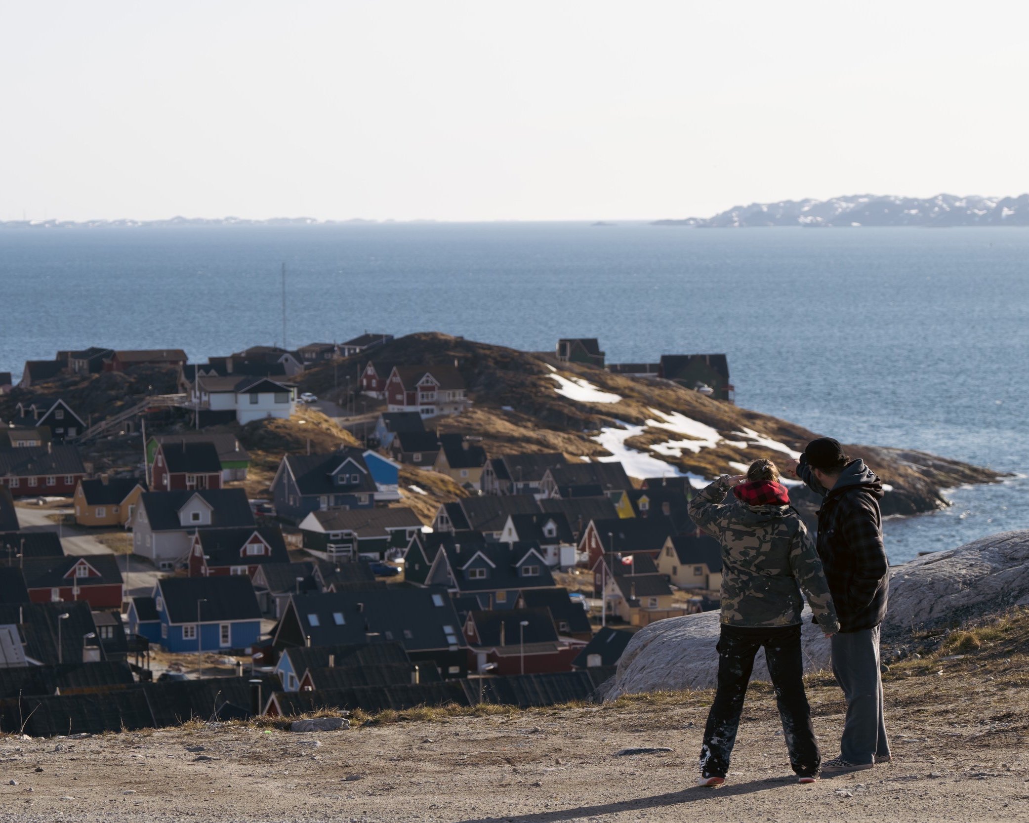  Cheeky and Jason Sikoak (Ilinniaqtuk Alumni) look out towards Nuuk, Greenland, May 2023. Photograph by Bronson Jacque. 