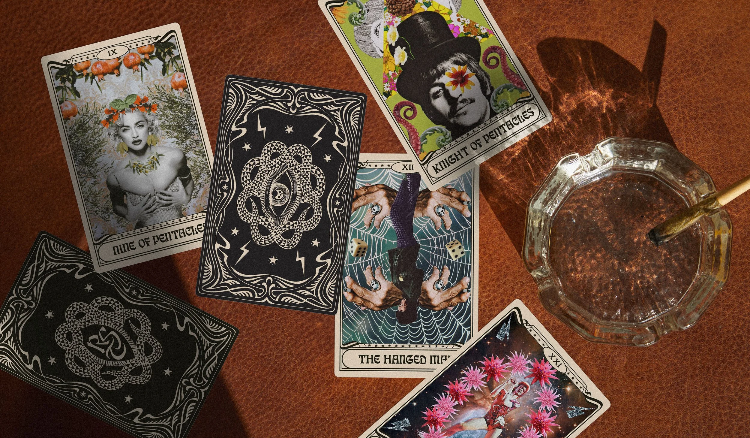 Collage-style tarot cards spread on brown leather surface