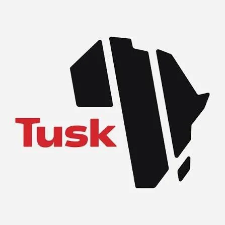 The word "Tusk" in red text with a grayscale illustration of a mammoth's head and tusks to the right.