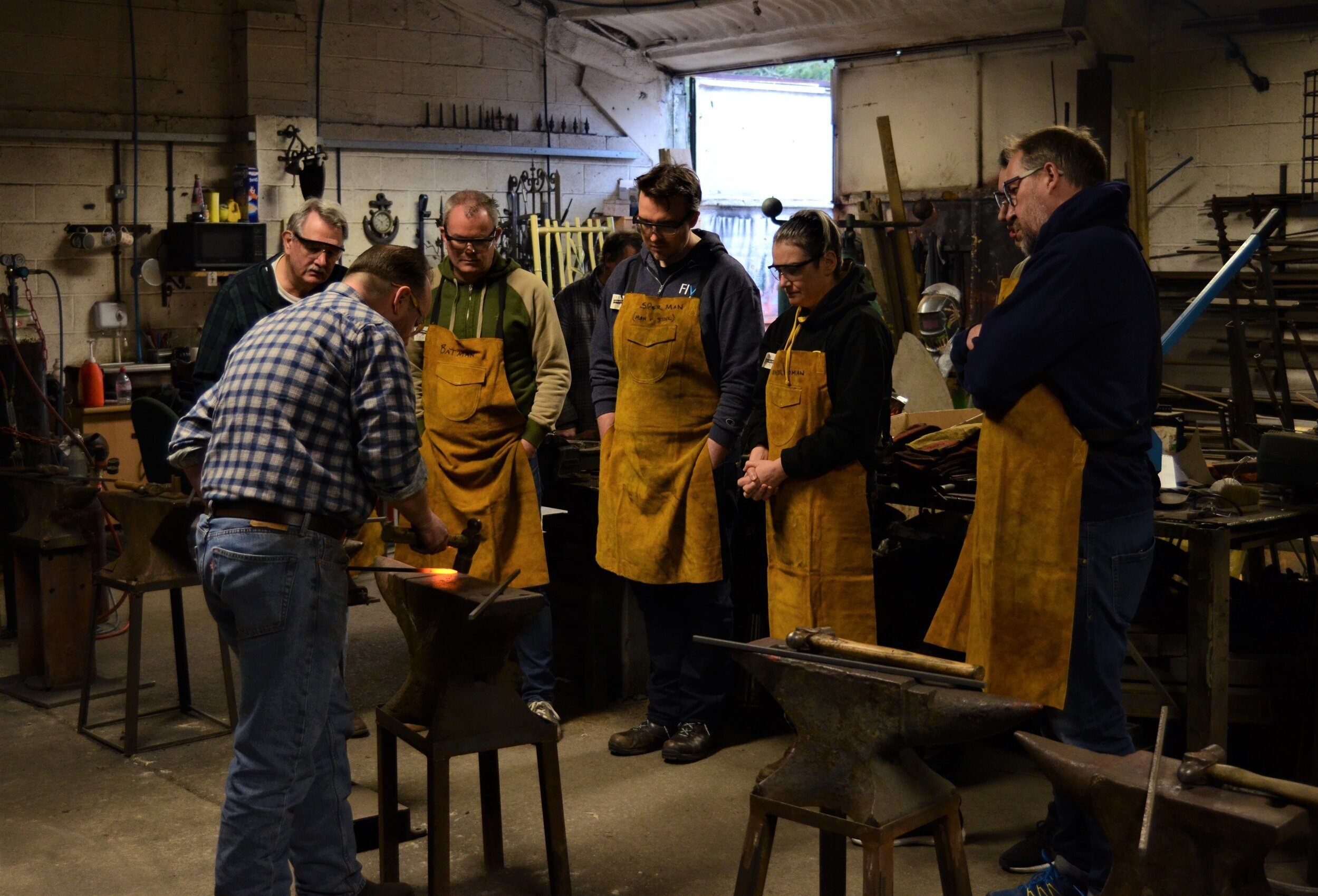 Mark demonstrating how to make a fire poker