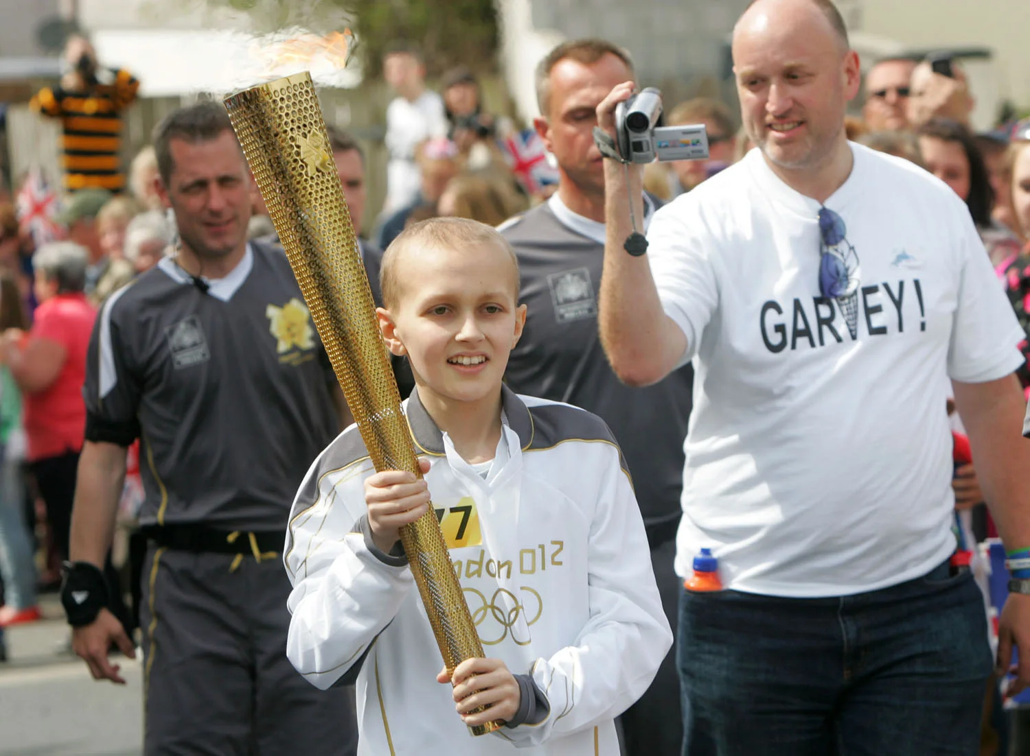  cancer survivor garvey evans carrying the olympic torch 