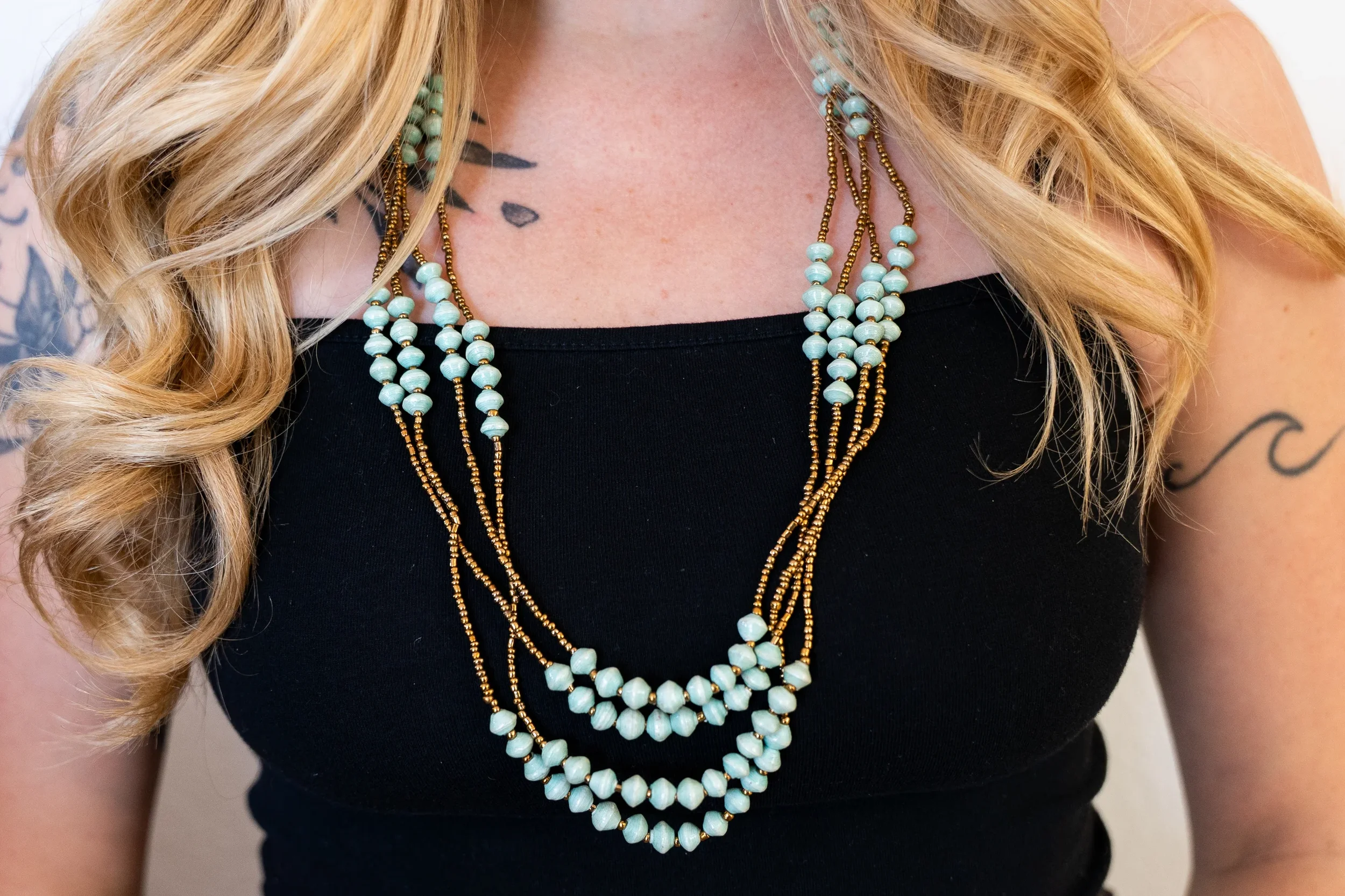 Mwebaza-Market-Four-Strand-Gold-Teal-Necklace-3.webp