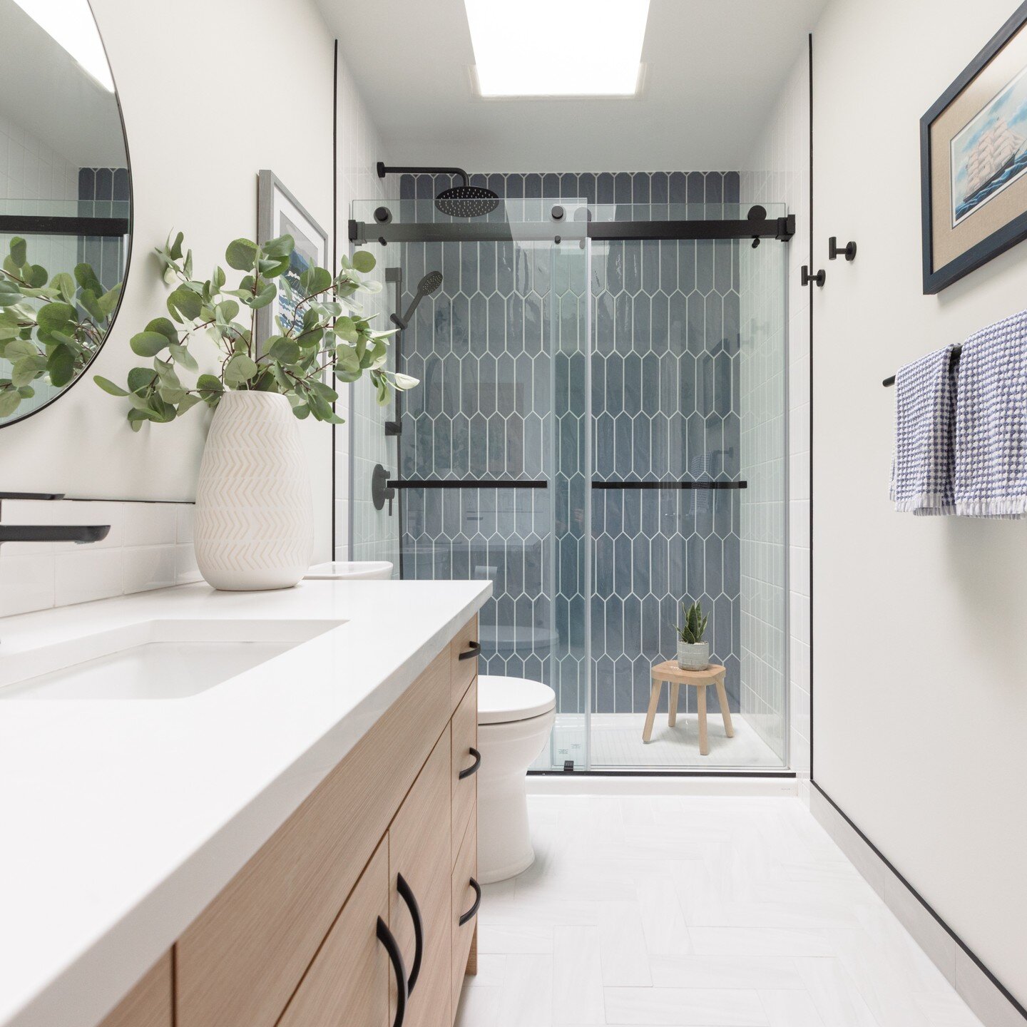 A timeless, yet fun little boys bathroom for these lucky kiddos. We kept the pallet fresh with simple white subway tile, and mixed in a larger picket tile in an ocean blue colour for some added flair. We finished off the floor with a soft grey floor 