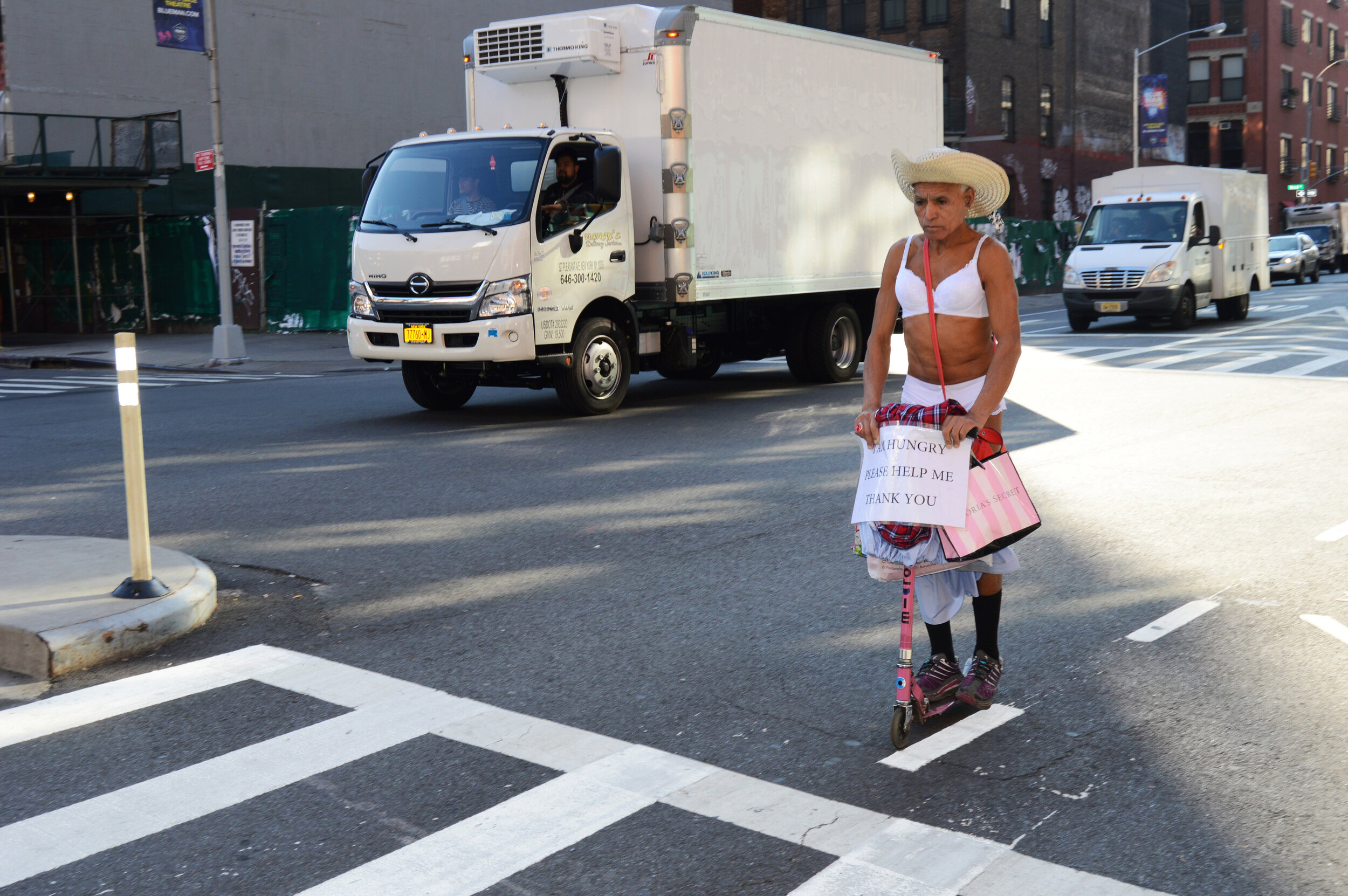  Brassiere sporting scooter rider on Lafayette Street. 