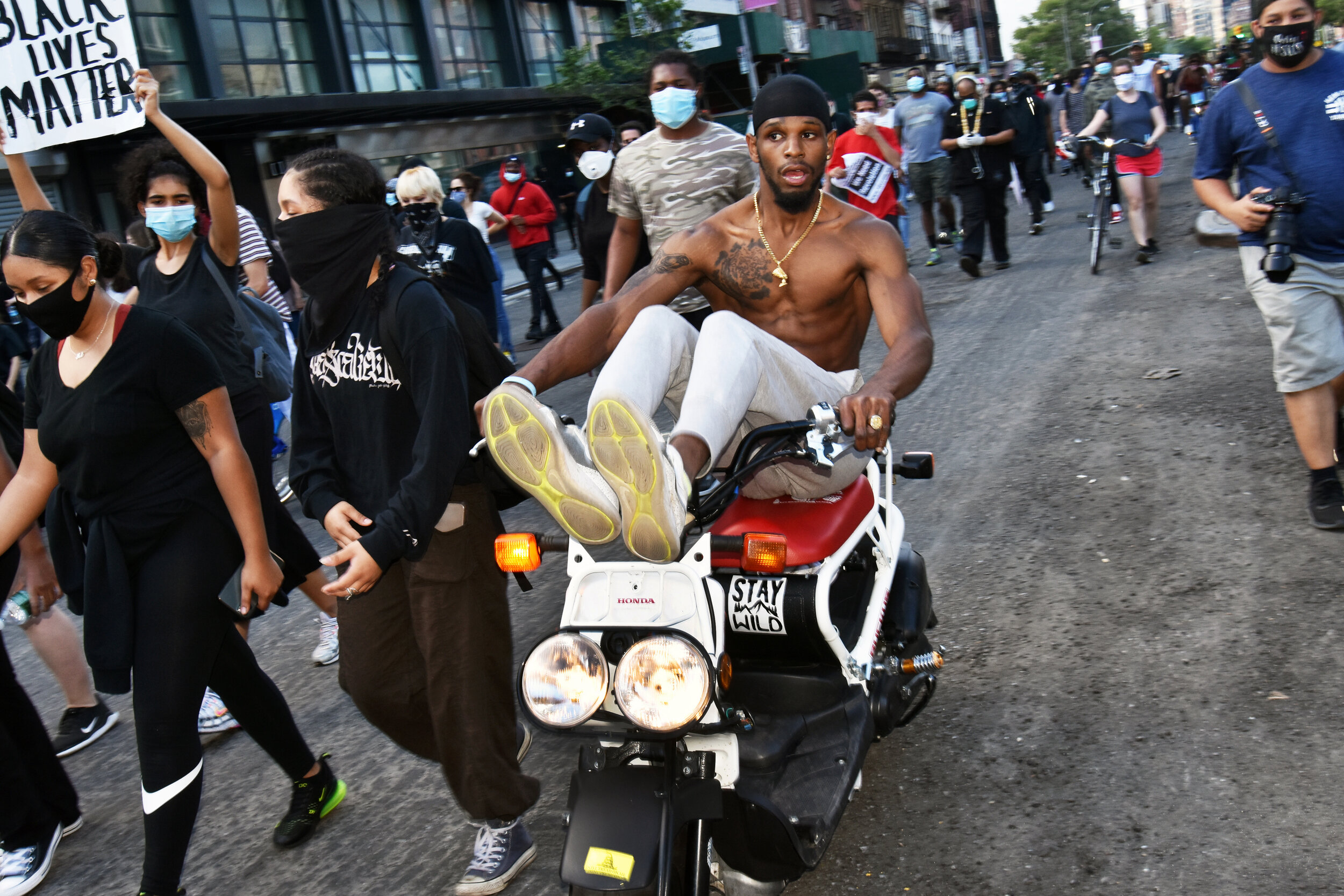  Man zooming down the Bowery at a BLM march on a scooter. 
