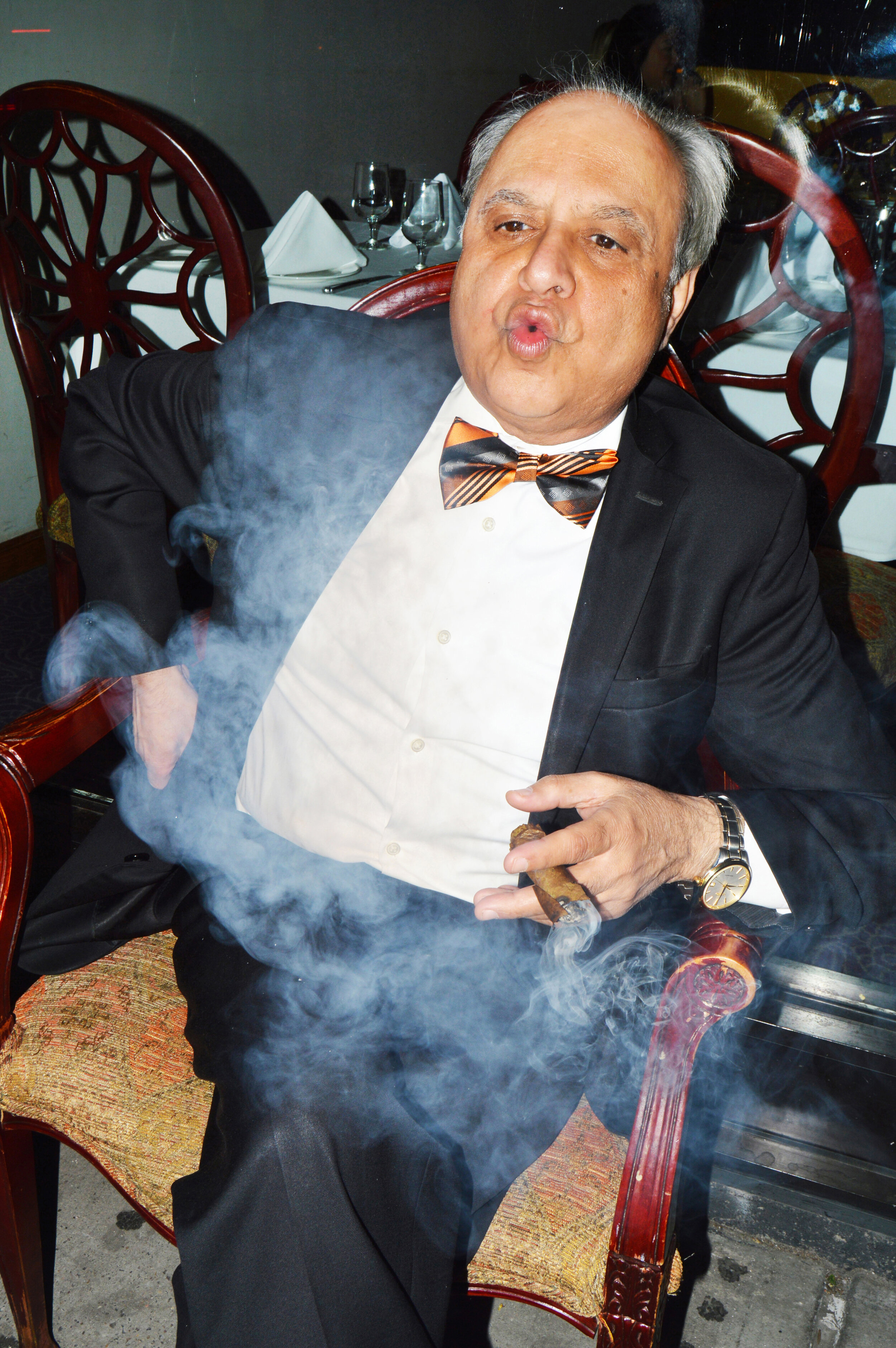  A restaurateur enjoying a cigar on Broadway. 