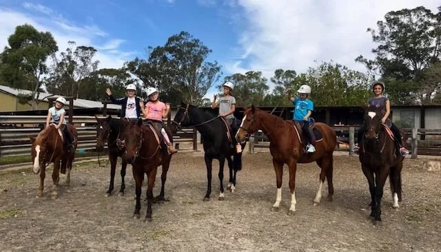 Children on horseback at a school holiday camp