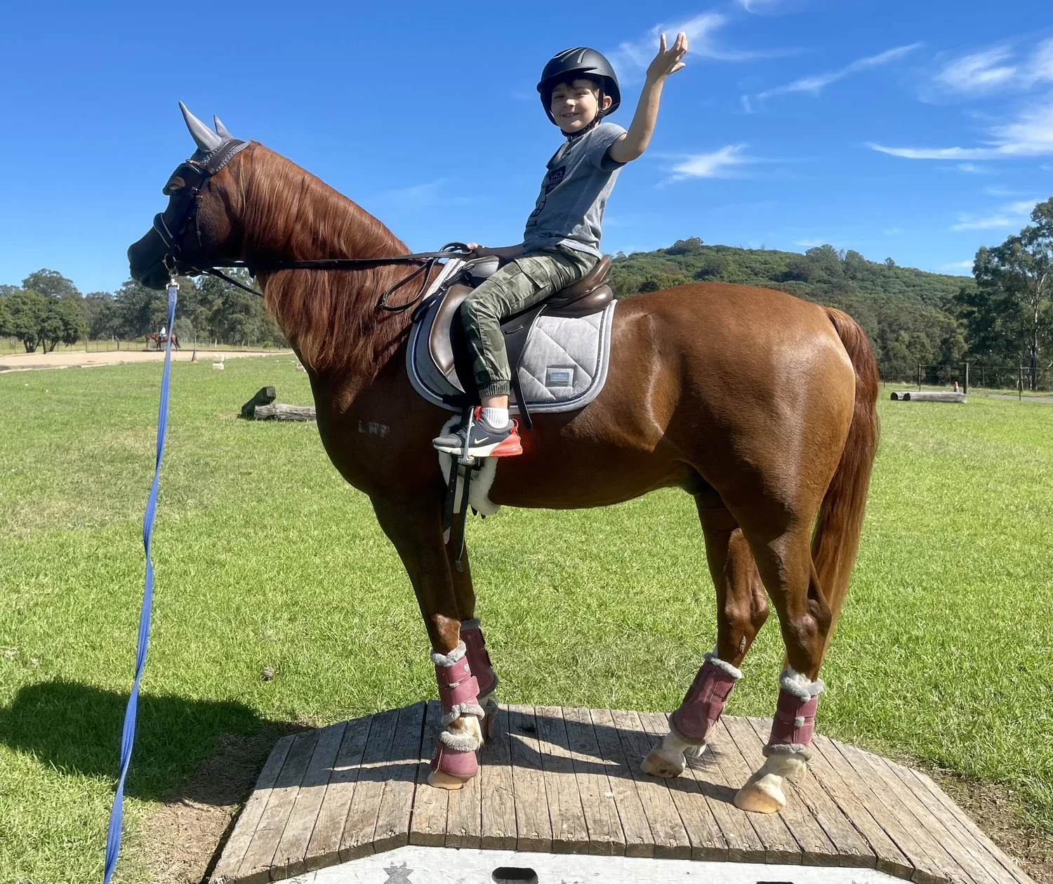 Child on a lead ride with a staff member walking beside the horse