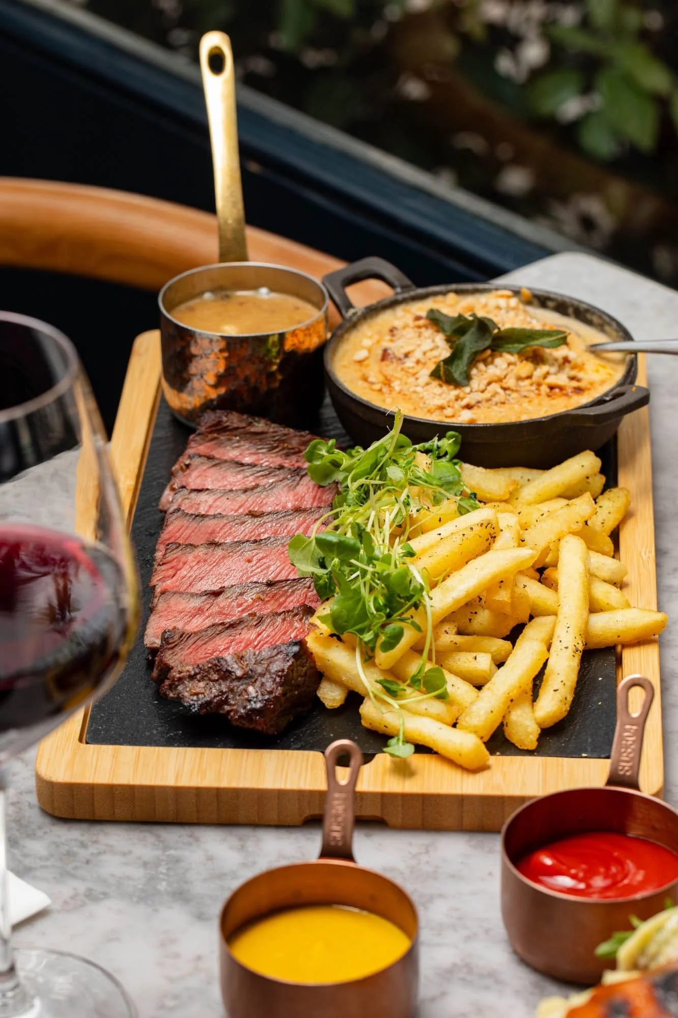 Steak lunch platter at with flat iron steak, fries and mac & cheese