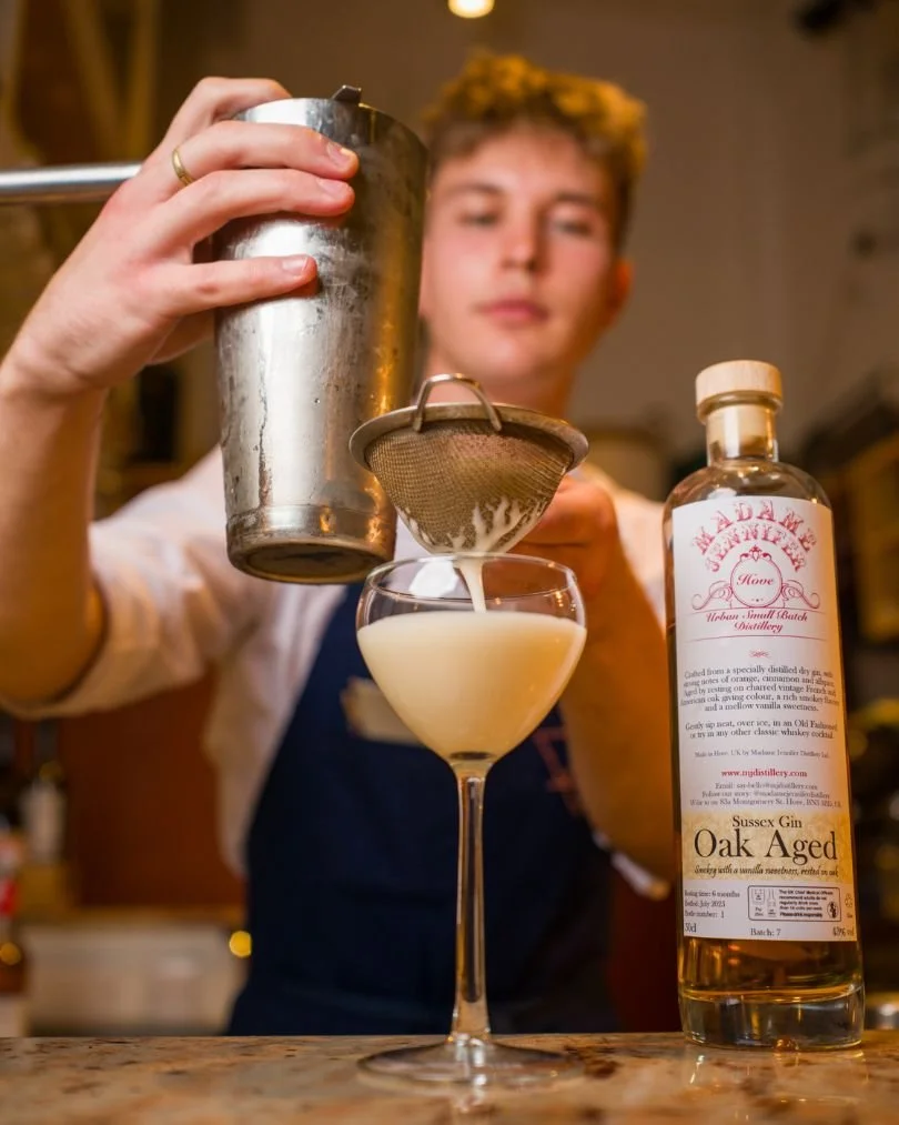 Bartender holding a cocktail shaker and a strainer. Image credit Tom Brown for Brighton Cocktail Week