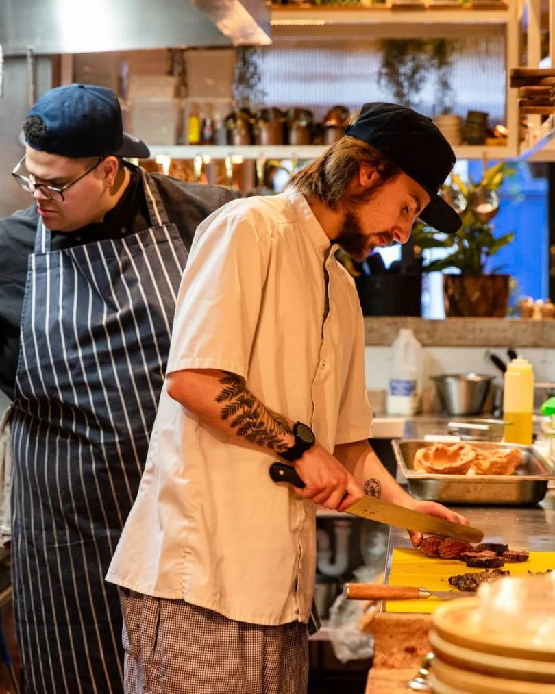 Two chefs working in the Kindling open kitchen