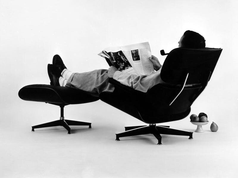 14.-The-World-of-Charles-and-Ray-Eames.-Charles-Eames-in-the-plywood-Lounge-and-Ottoman-1956.-©-Eames-Office-LLC.jpg
