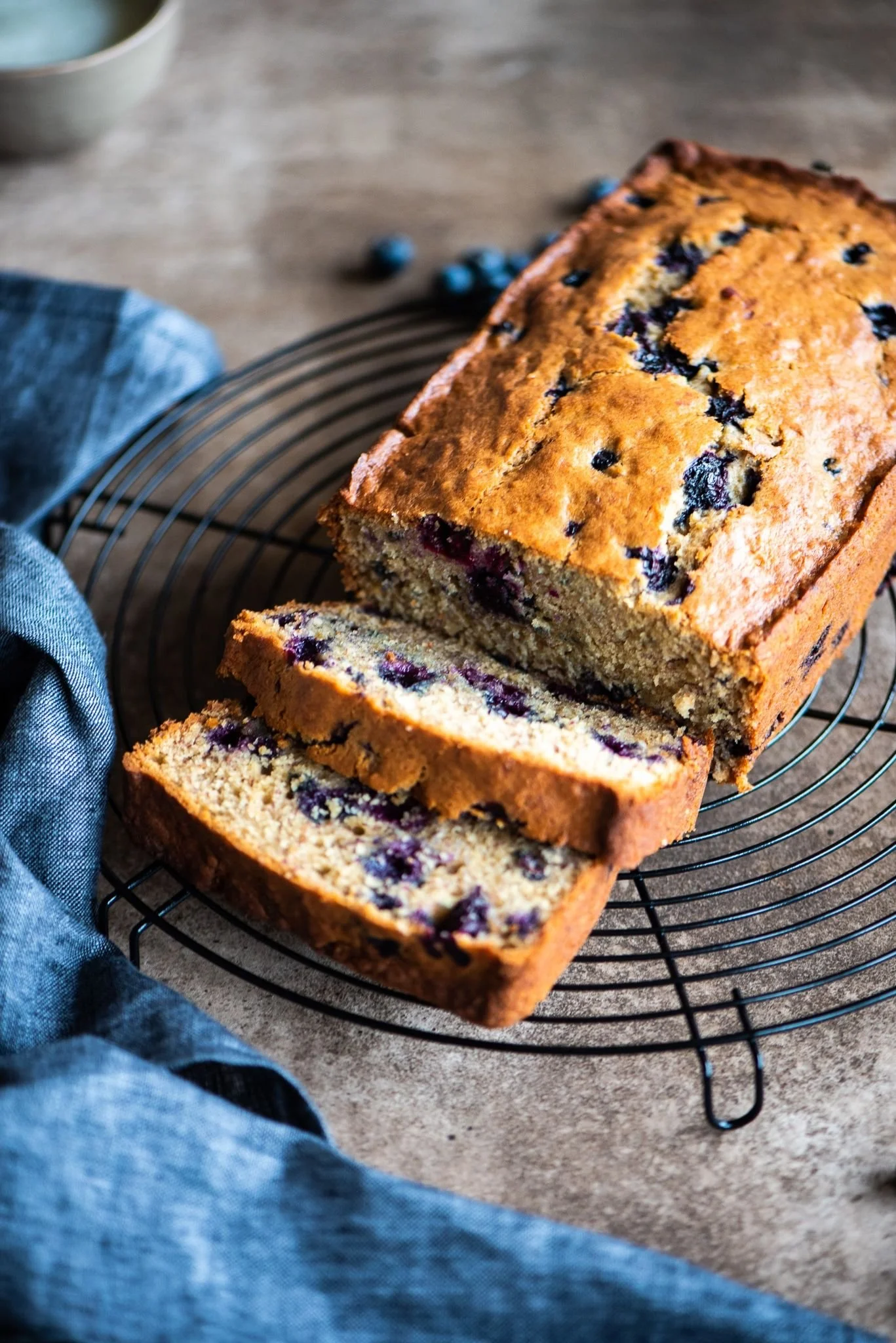 Honeyberry loaf cake on a wire cooling rack with slices cut