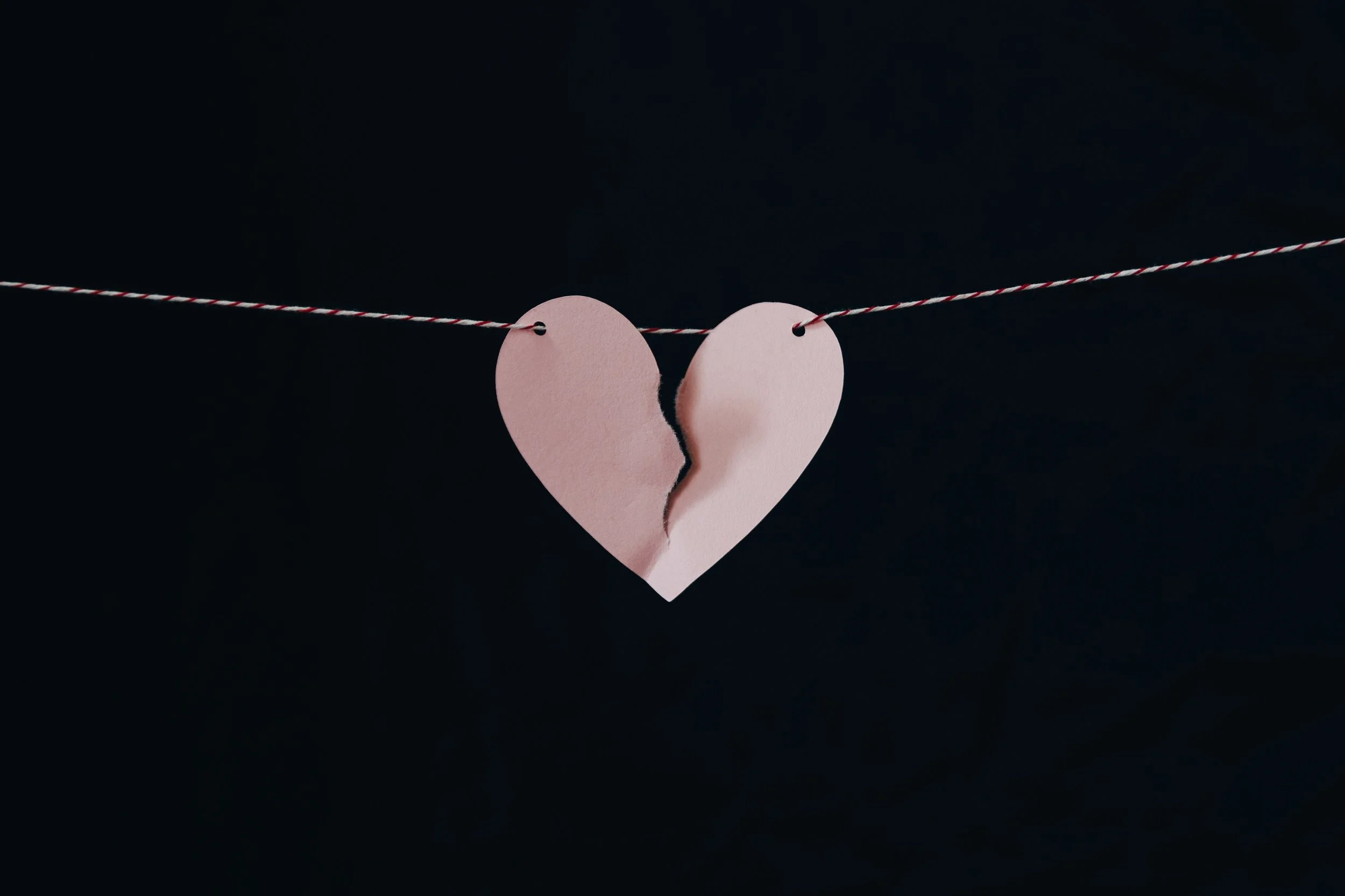 broken heart hanging on a wire| Kelly Sikkema | Unsplash