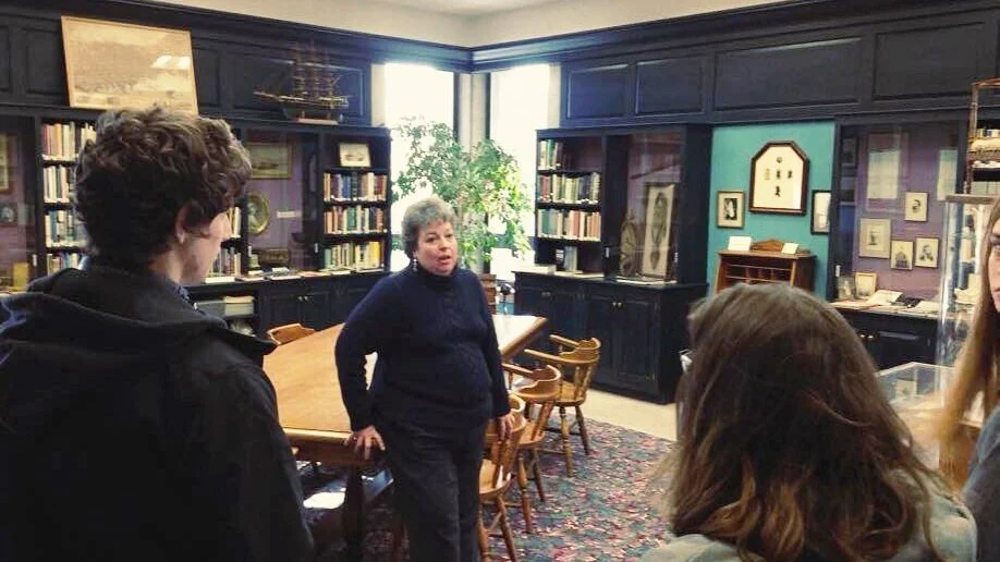 Group+of+students+in+Herman+Melville+Memorial+Room+learning+about+local+history.jpeg