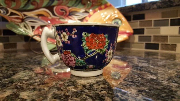 Teacup with a blue background and floral design