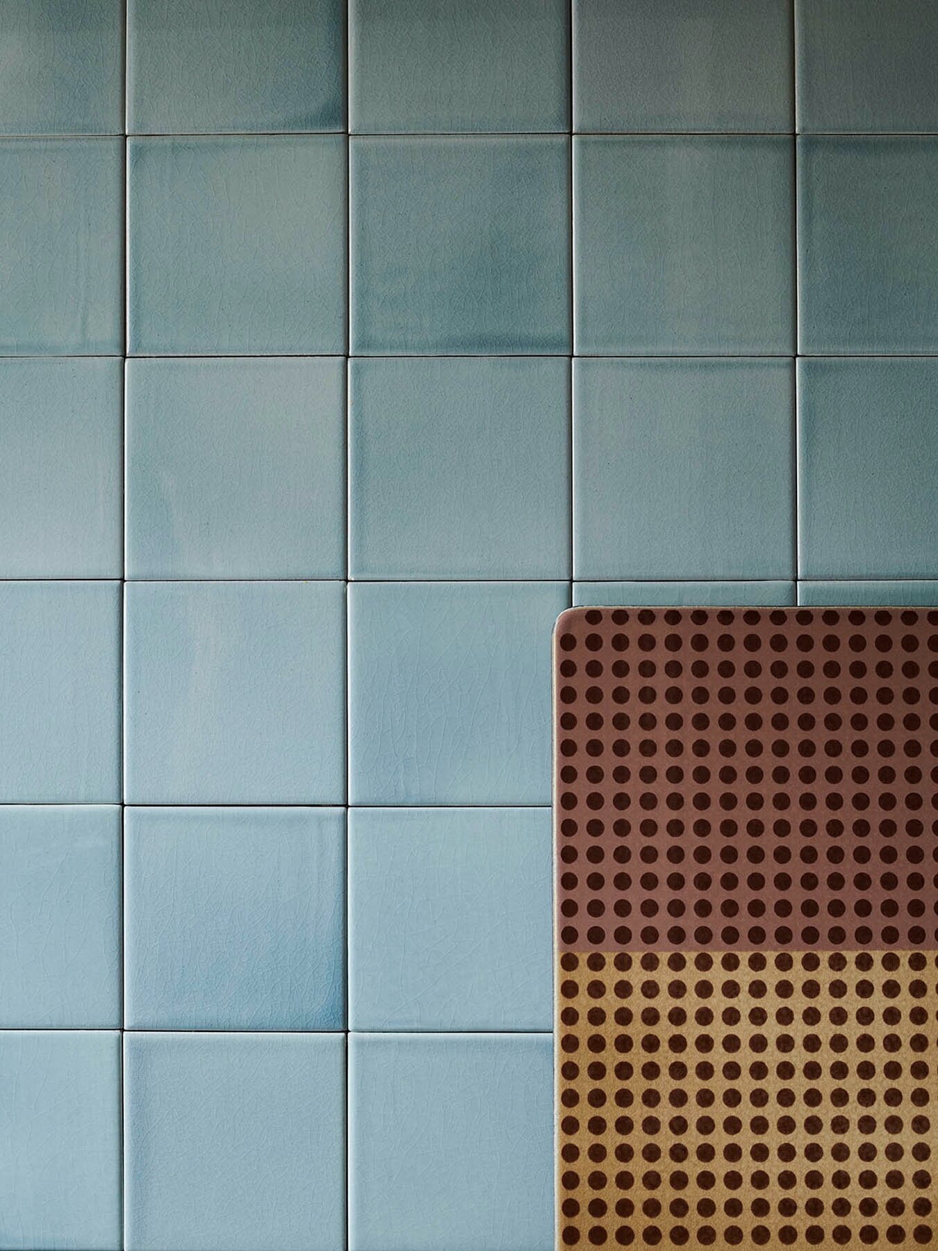 Wall with clay tiles in format 10x10x1 cm glazed with 'Blue Smoke Shiny Crystal'