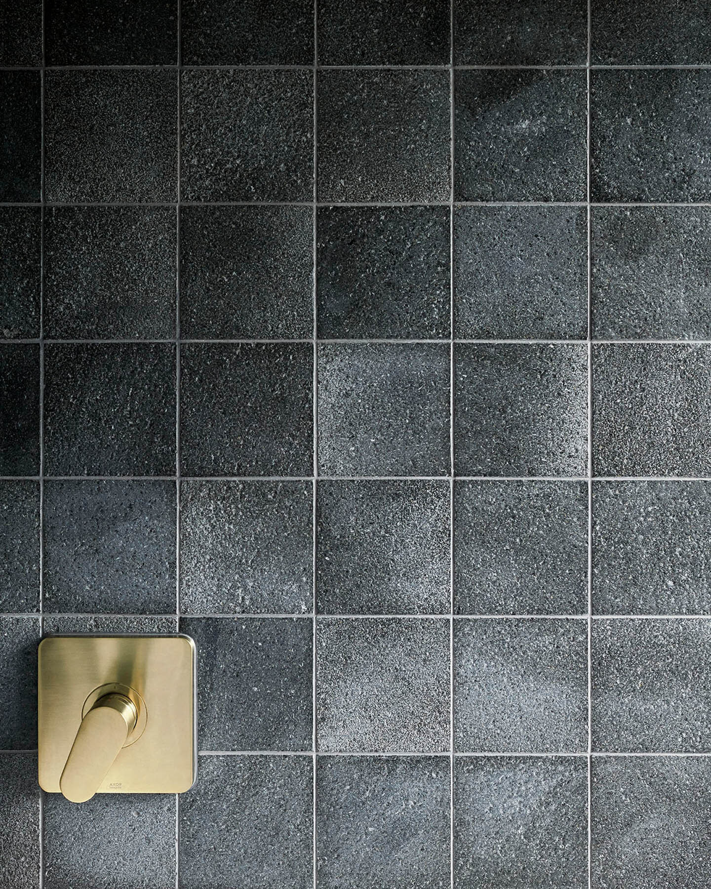 Wall with natural raw lava stone tiles with brush hammered finish in format 15x15x1 cm  (Copy)