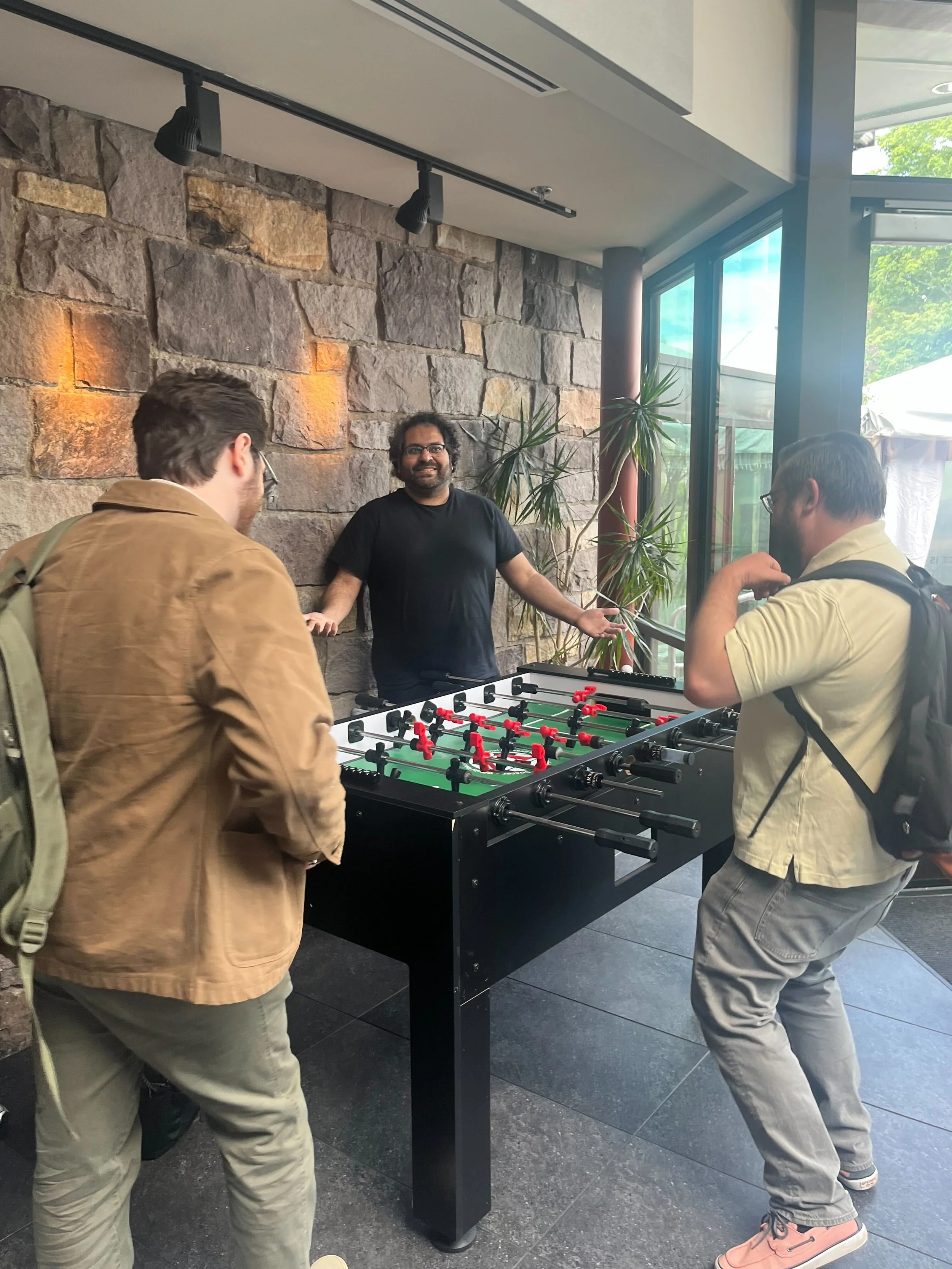 Wes gets cooked by Rafiq in a  game of foosball