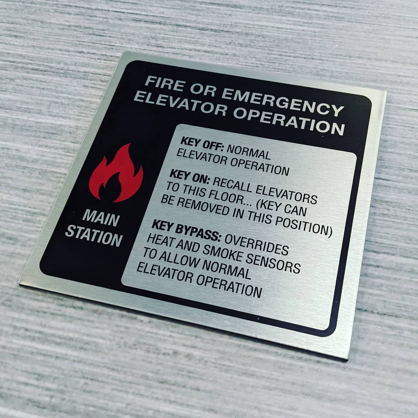 Required safety signage doesn't have to look cheap and boring.  Check out this elevator sign we just finished.

Satin finished clear print on brushed ACM.