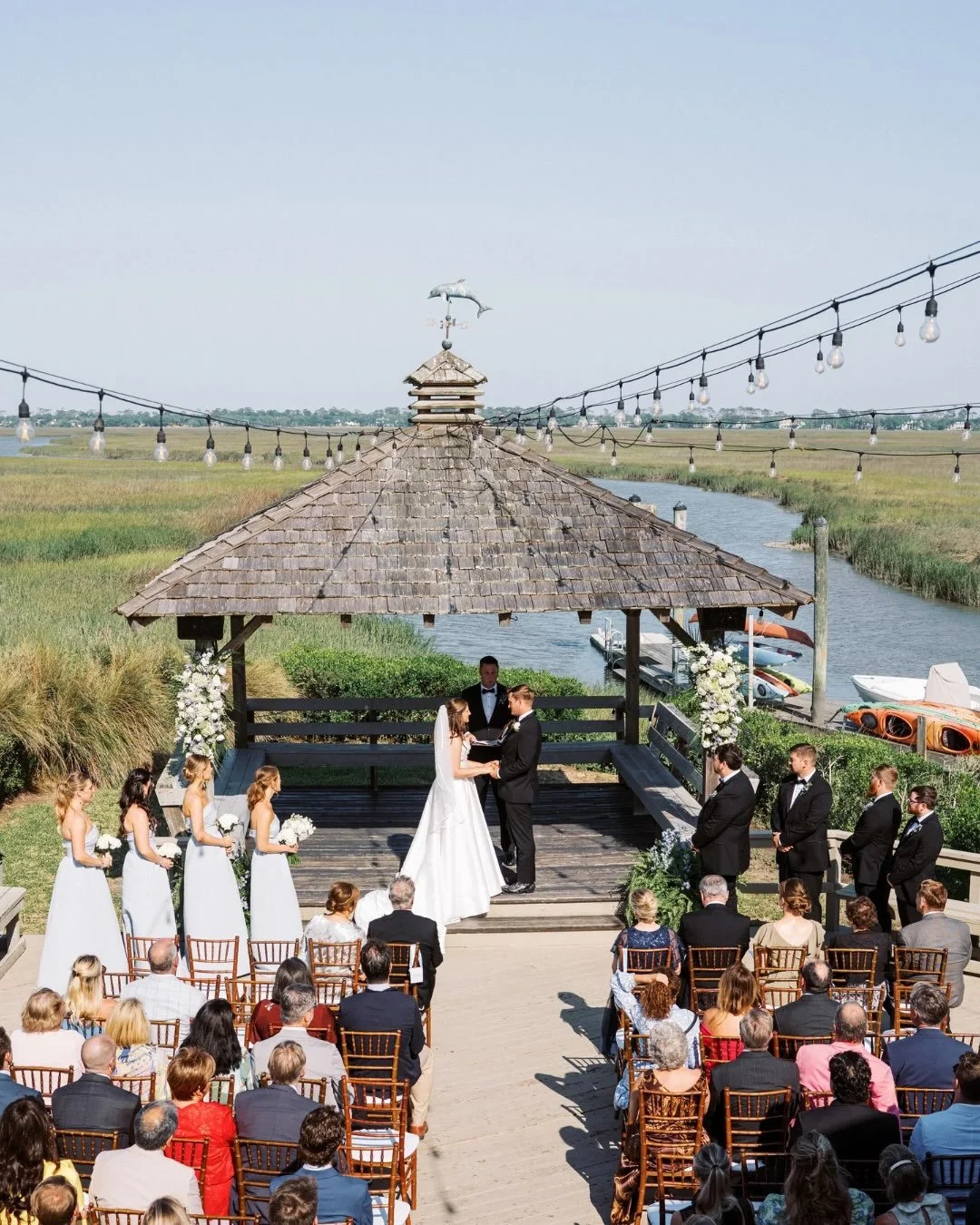 By day, breathtaking views. By night, unforgettable ambiance. The beauty of your celebration doesn&rsquo;t end when the sun goes down - if simply shines in a new light. 
📸 @allisonpedigo 
.
.
.
.
#weddingvenue #coastalwedding #vcl #goldenisles