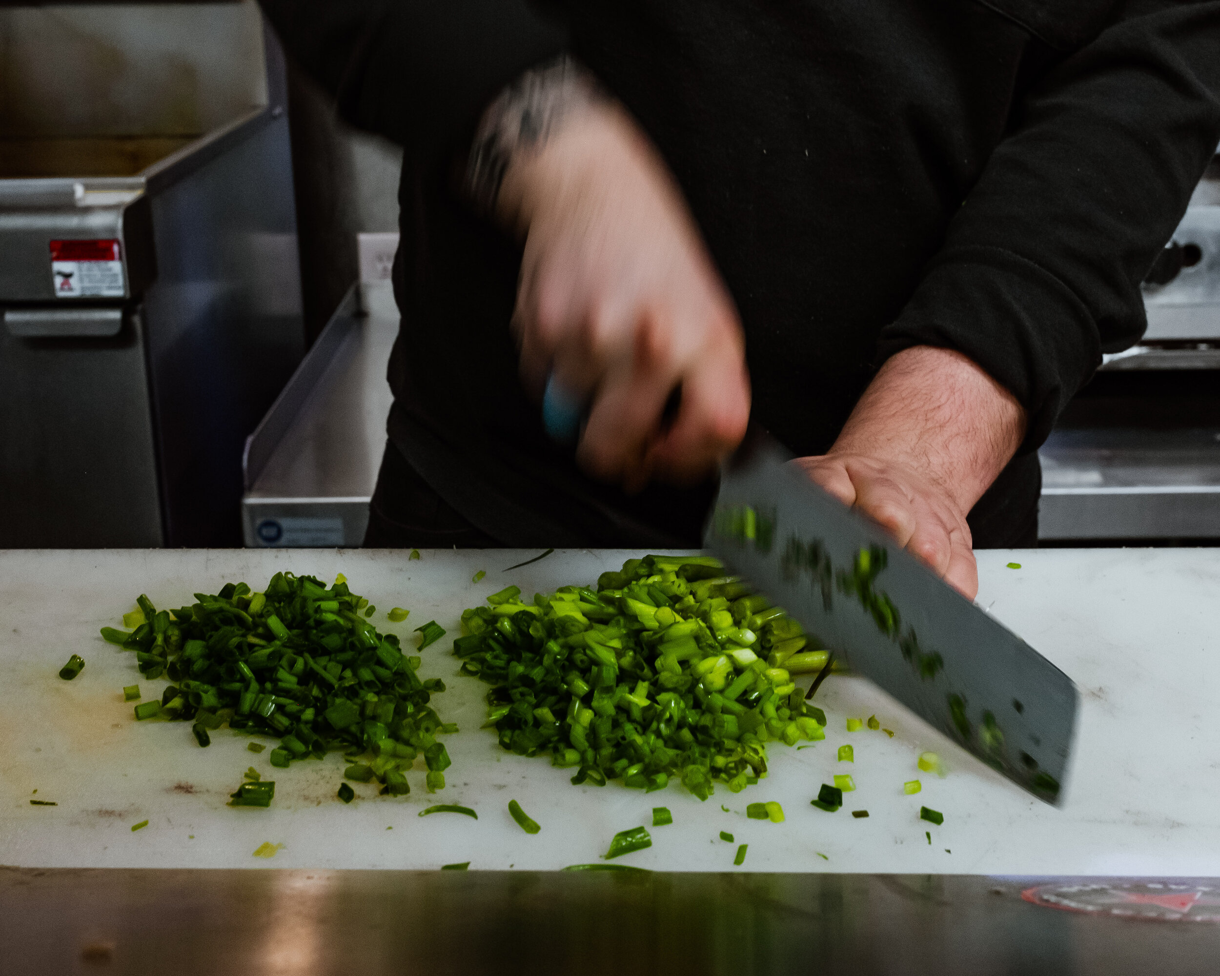 chef chopping green onions