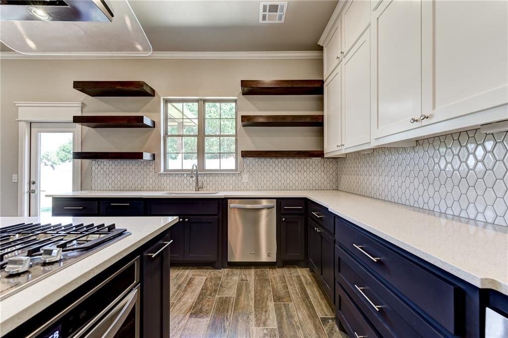 two tone kitchen cabinets white upper cabinets navy blue lower cabinets open floating shelves.JPG