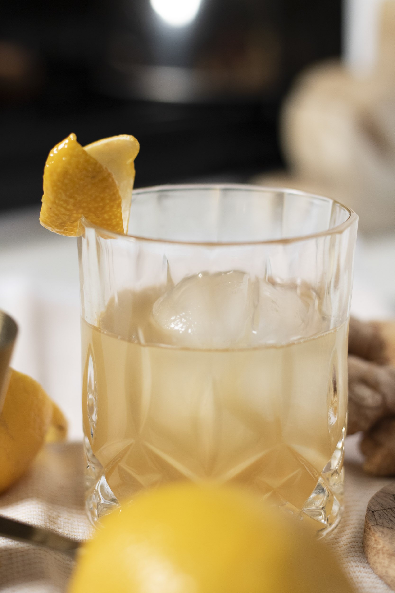 Cocktail with large ice cube and lemon twist Stock Photo