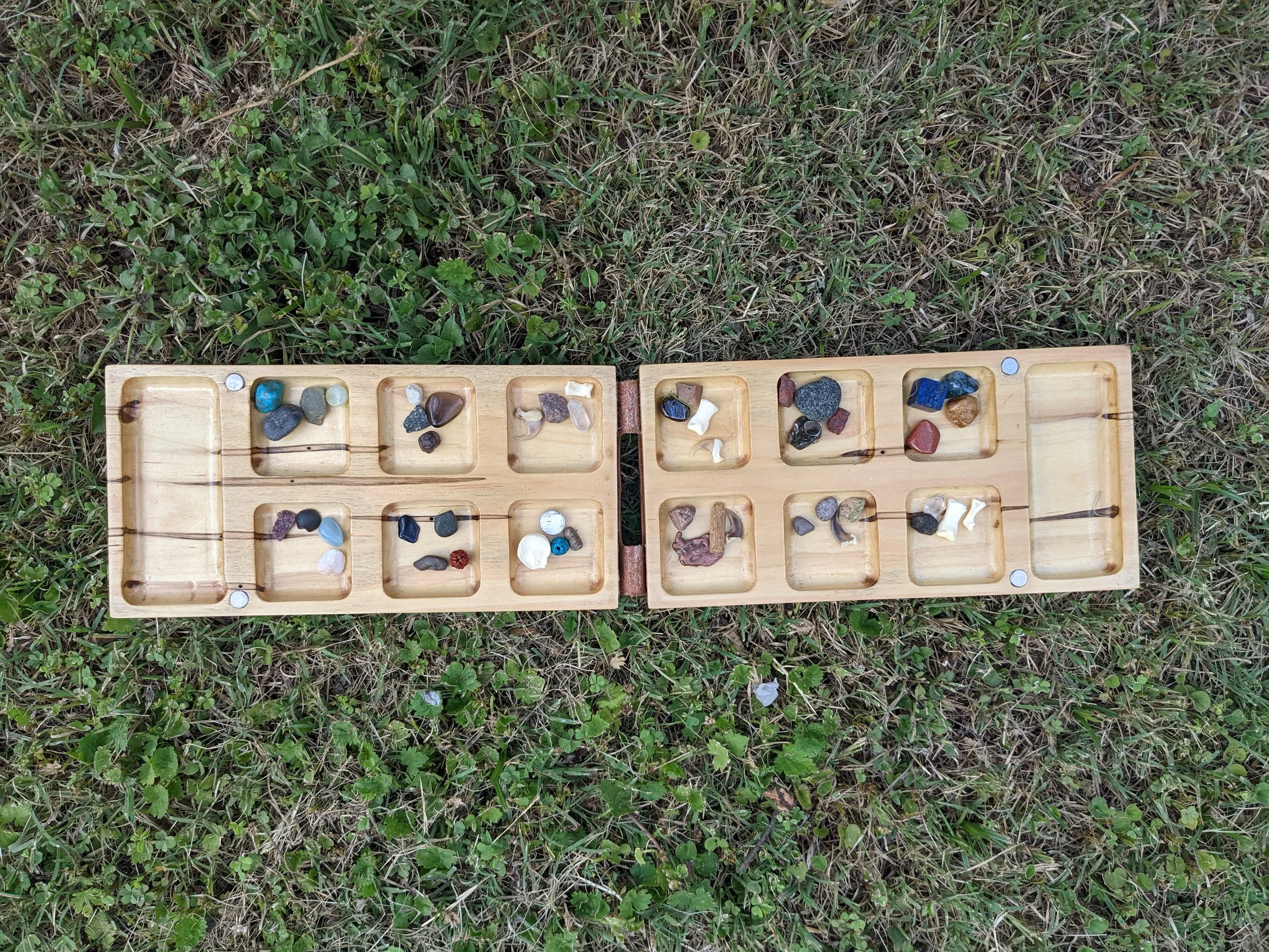  Mancala board with found objects used for pieces 