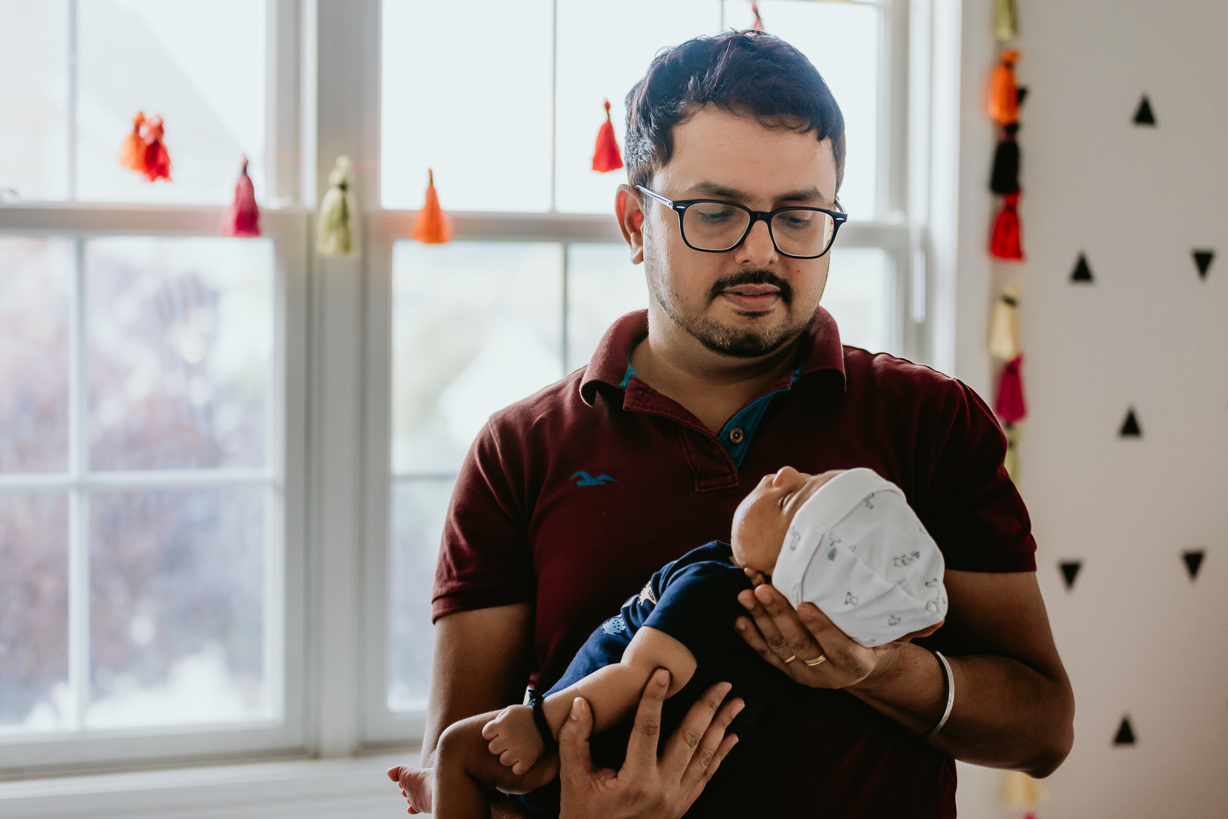  Connecticut Lifestyle Newborn Portrait of father holding his son in front of window 