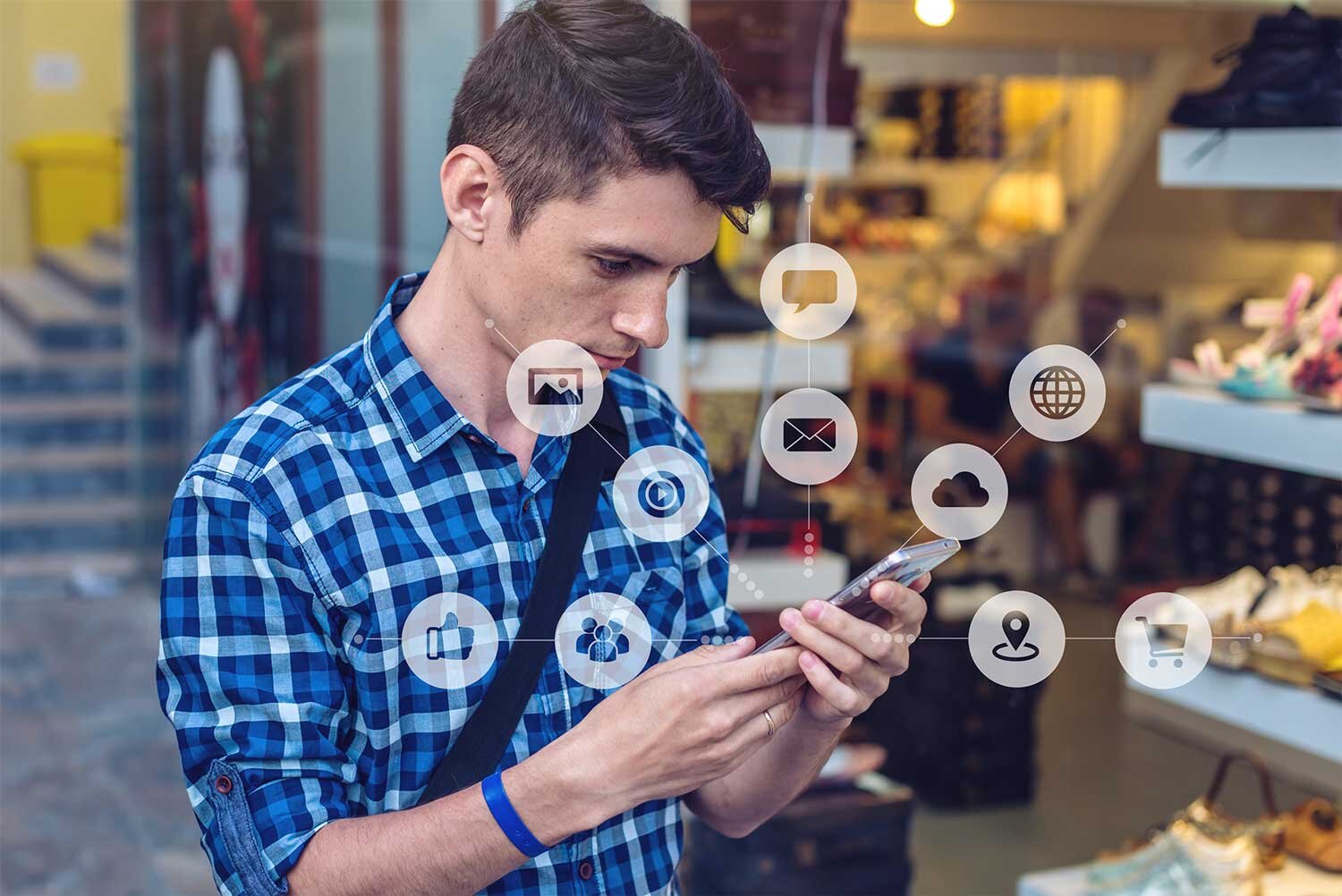 Man-using-a-smartphone-at-a-store-and-digital-marketing-icons-hover-around-the-phone.jpg