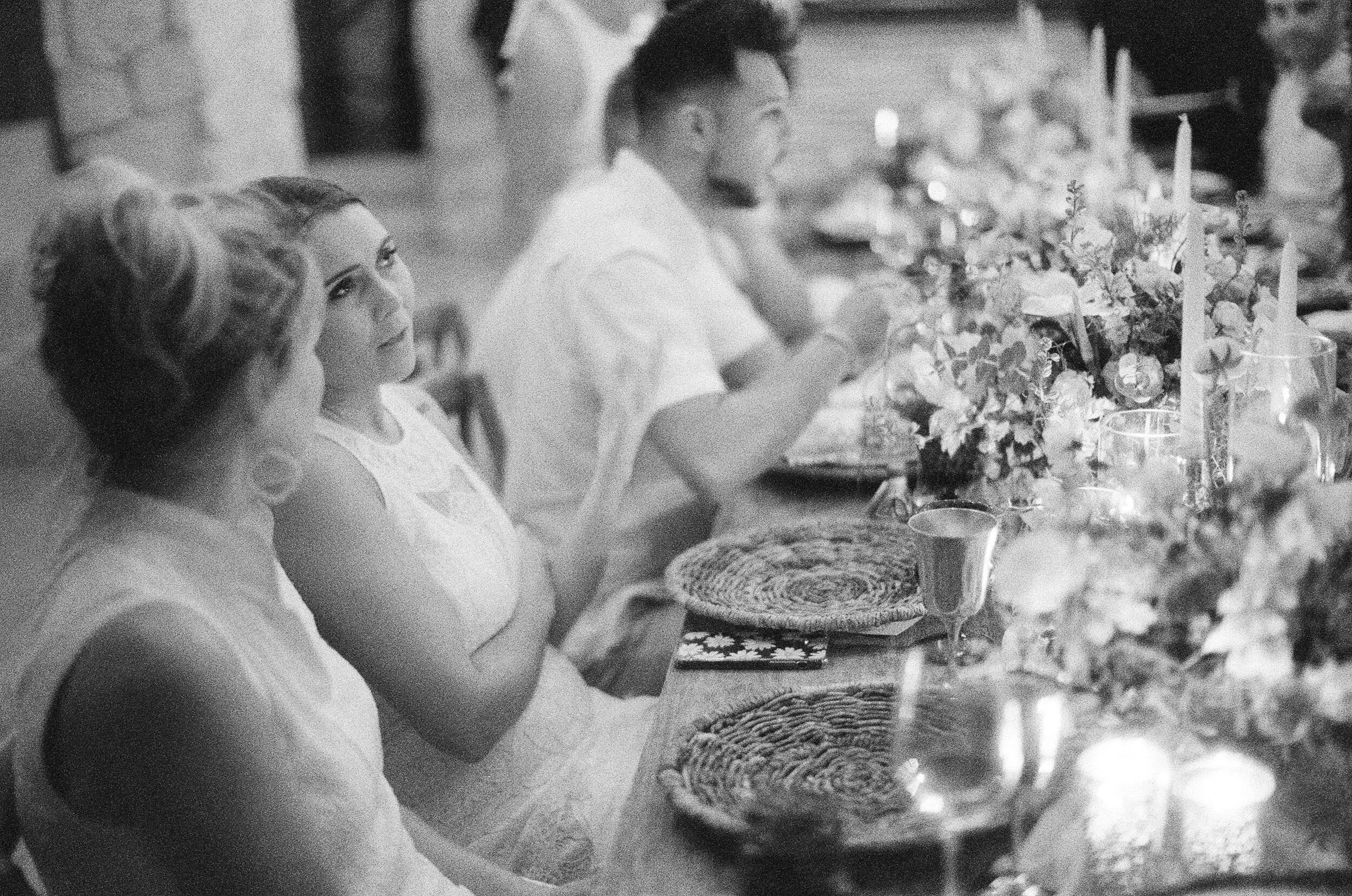 Wedding guests sitting at their dinner tables while social distancing
