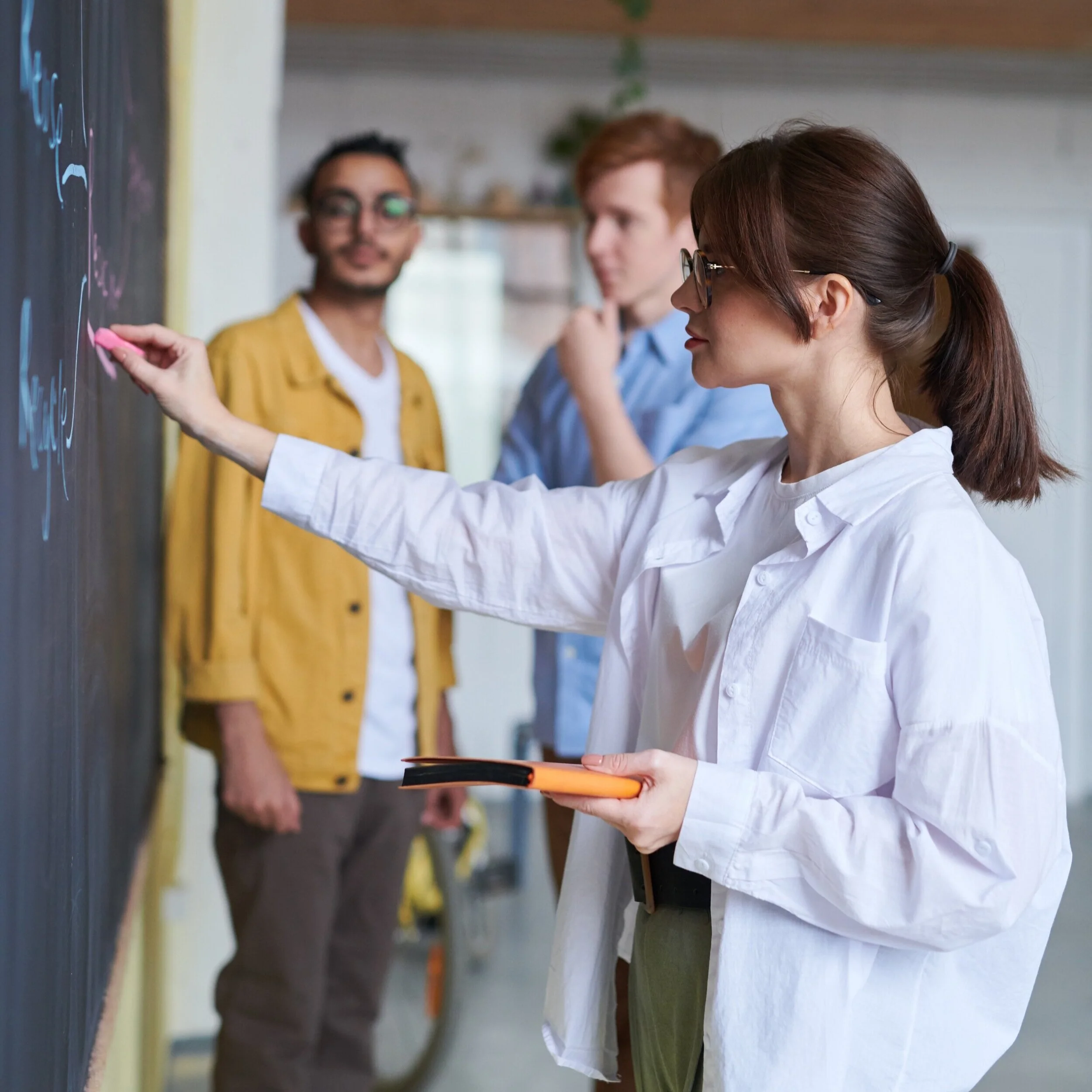 photo-of-woman-writing-on-blackboard-3184644.jpg