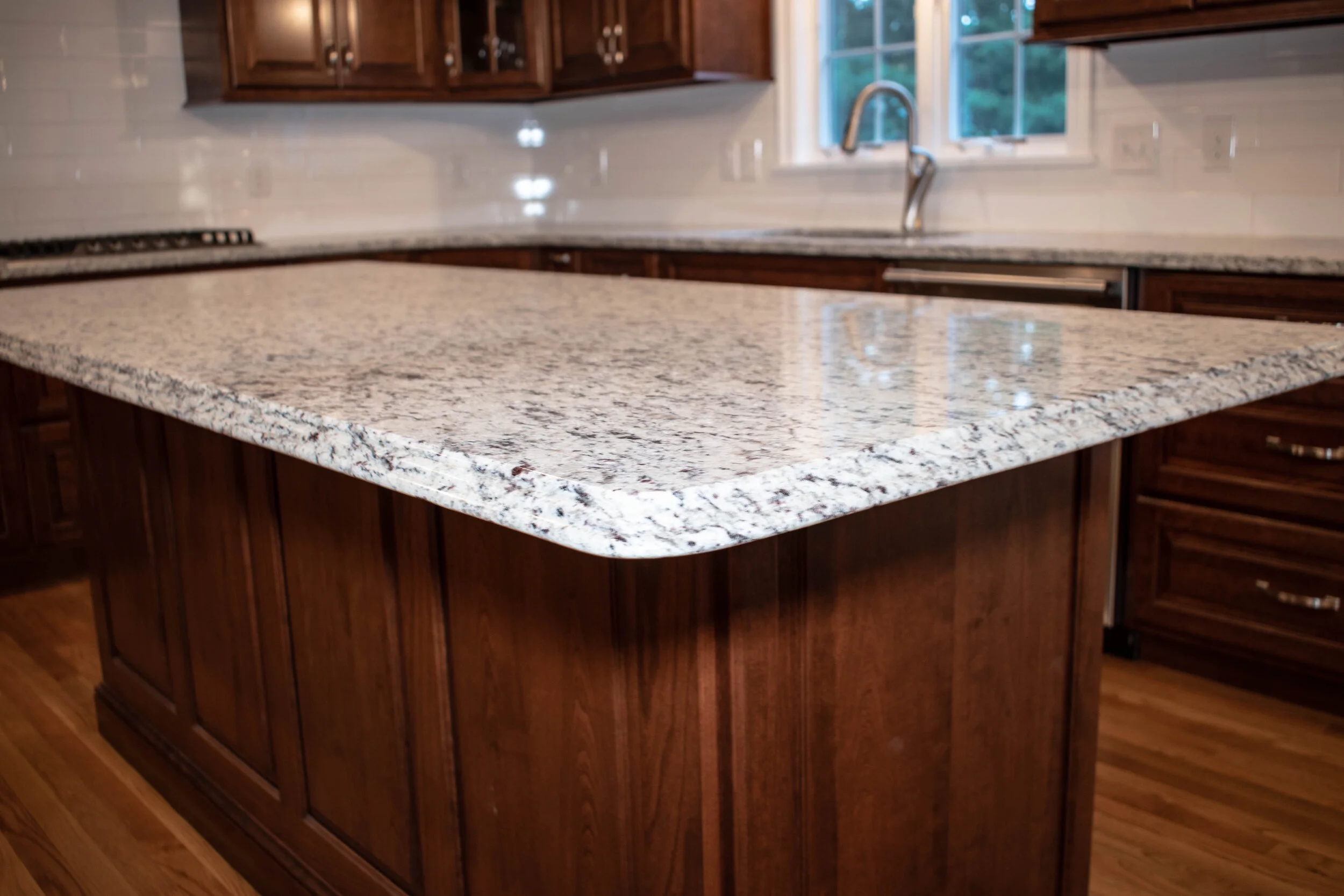 Material: SF / White Ornamental Thickness, Finish & Stone Type: 3CM Polished Granite Edge: Main Counters: Eased Island: Waterfall Sink: KB18-SP4