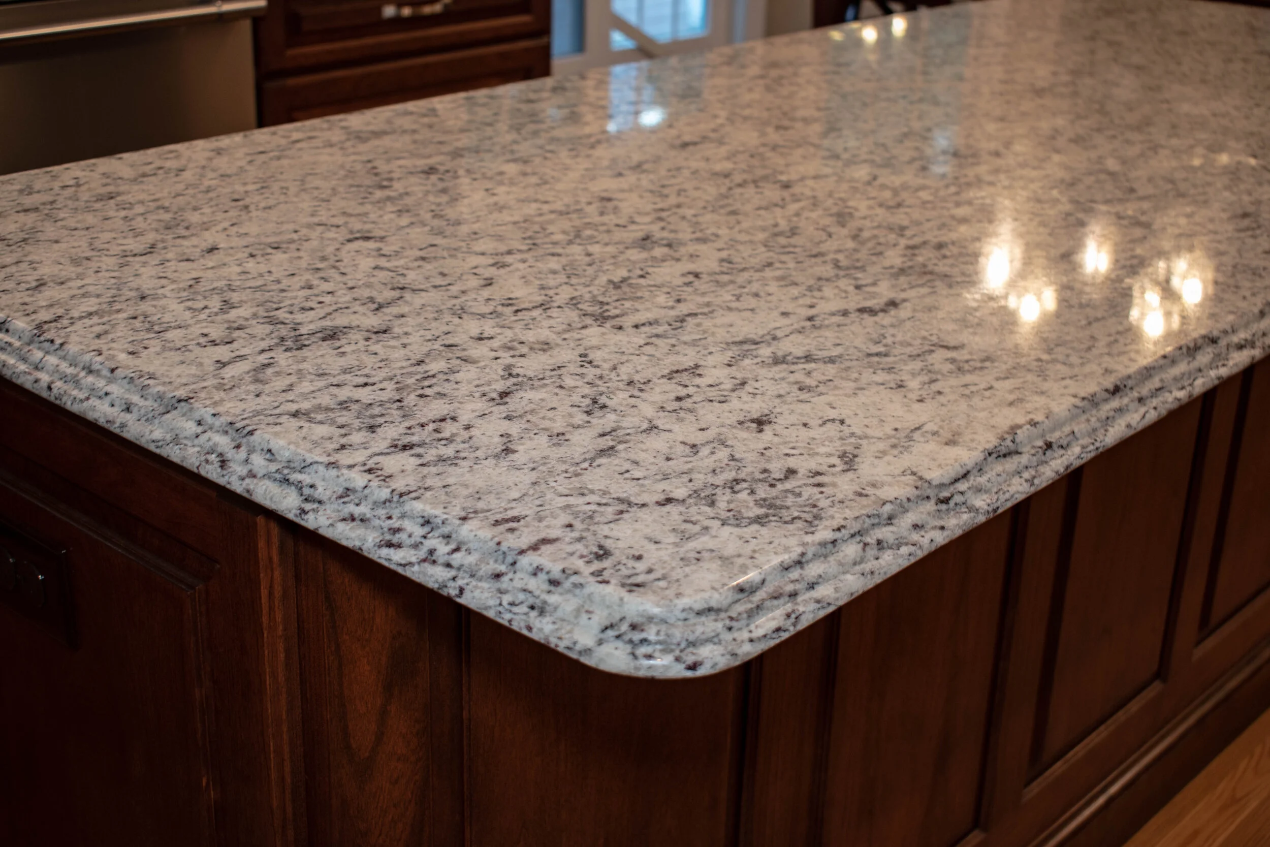 Material: SF / White Ornamental Thickness, Finish & Stone Type: 3CM Polished Granite Edge: Main Counters: Eased Island: Waterfall