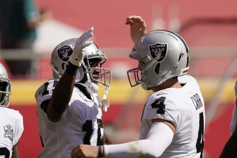  Las Vegas Raiders wide receiver Nelson Agholor (left) celebrates with quarterback Derek Carr after catching a 59-yard touchdown pass during the first half of an NFL football game against the Kansas City Chiefs on Sunday in Kansas City (Charlie Riede