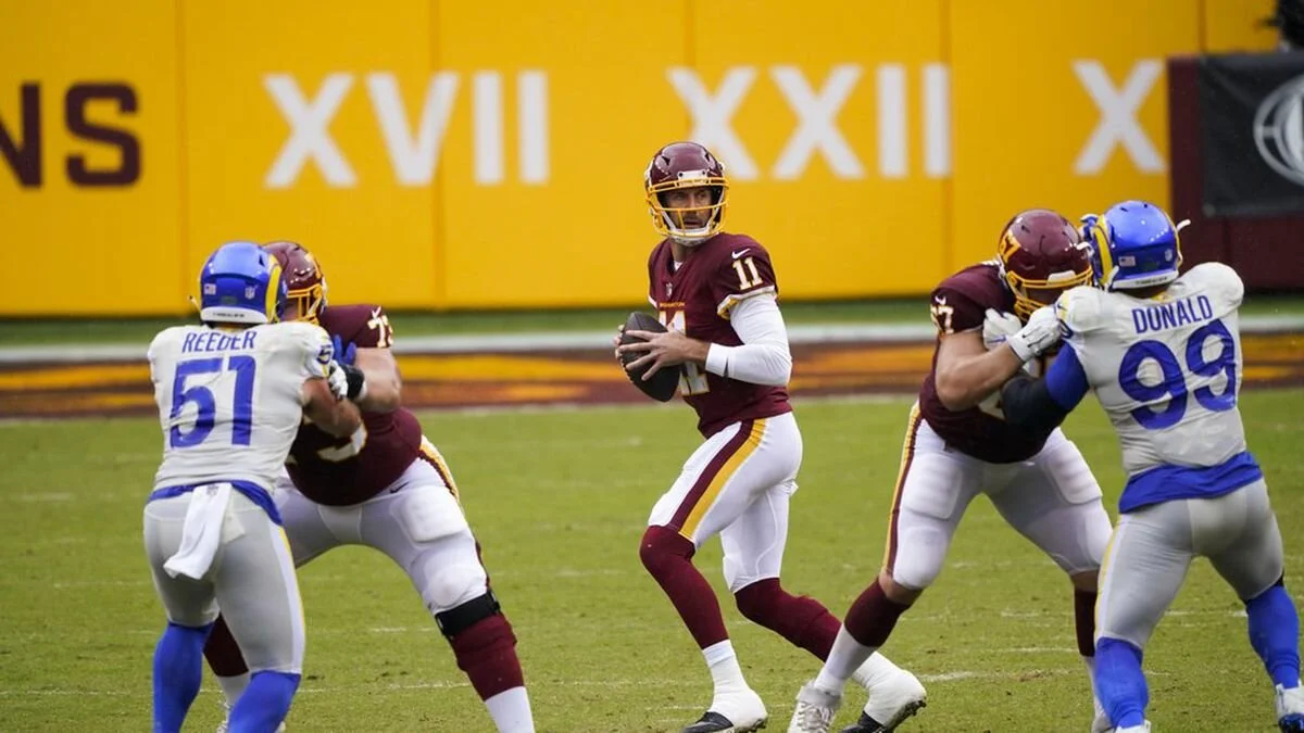  Washington Football Team's Alex Smith (11) drops back to pass during the first half of an NFL football game against the Los Angeles Rams on Sunday, in Landover, MD (Susan Walsh/AP Photo). 