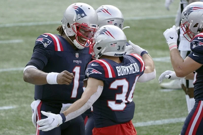  New England Patriots quarterback Cam Newton (left) celebrates his touchdown pass to running back Rex Burkhead in the first half of an NFL football game against the Las Vegas Raiders in September, in Foxborough, MA (Charles Krupa/AP Photo). 