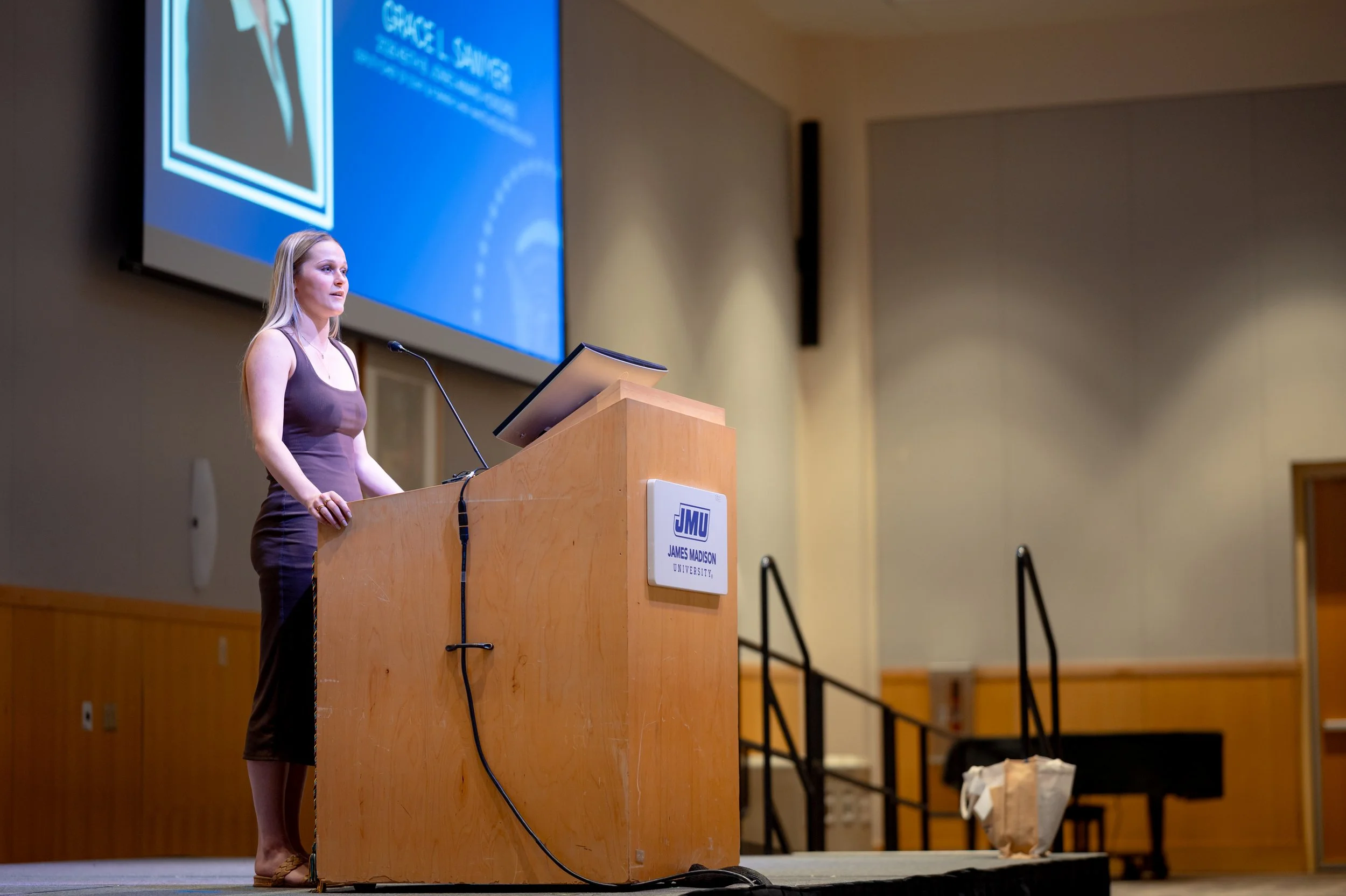  Grace L. Sawyer delivers her acceptance remarks during ceremony honoring her as the inaugural Keith B. Jones Award for Excellence in Political Journalism recipient in Harrisonburg, Virginia on Tuesday, May 5, 2026. (Landon Shackelford/AKSM Photograp