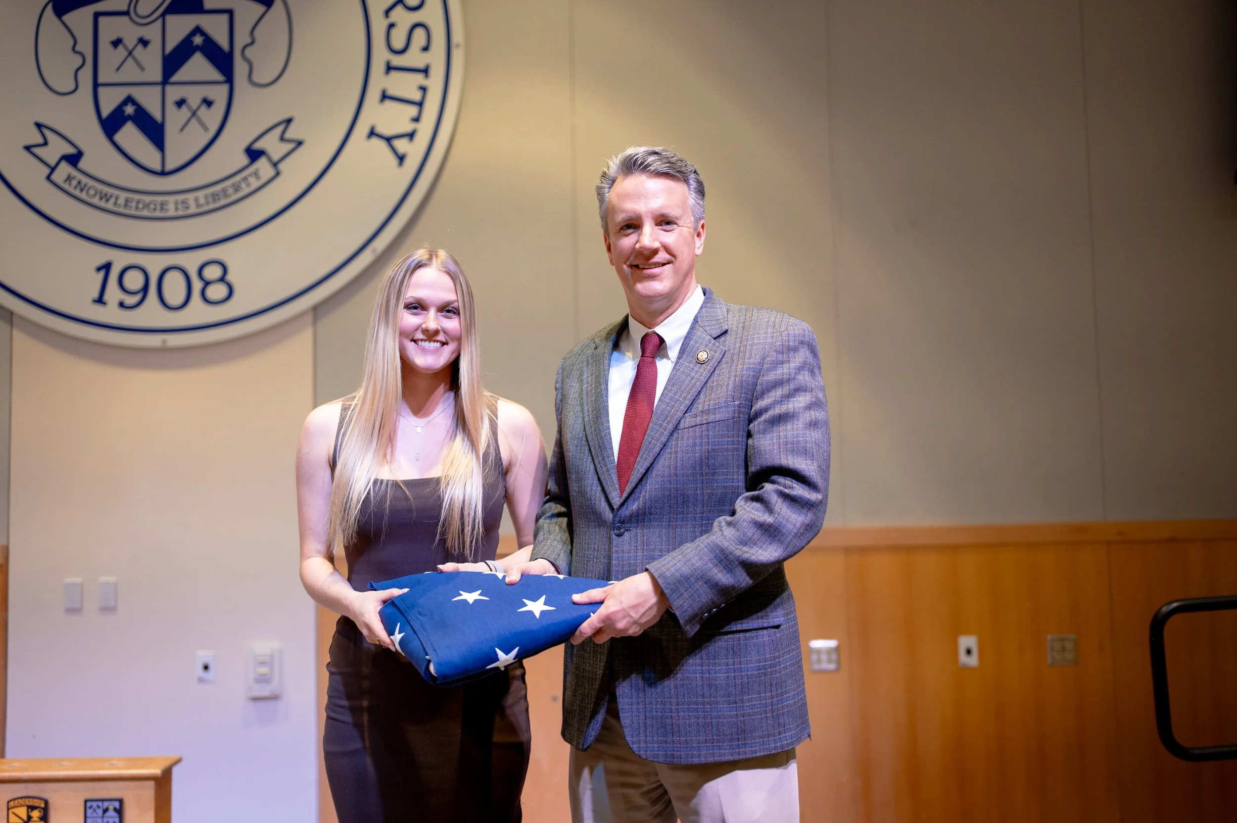  Former Chief White House Producer and Deputy Chief of Staff Grace L. Sawyer and United States Congressman Ben Cline (VA-06) pose for a photo with a flag that was flown over the United States Capitol Building on Sawyer’s last day at the White House o