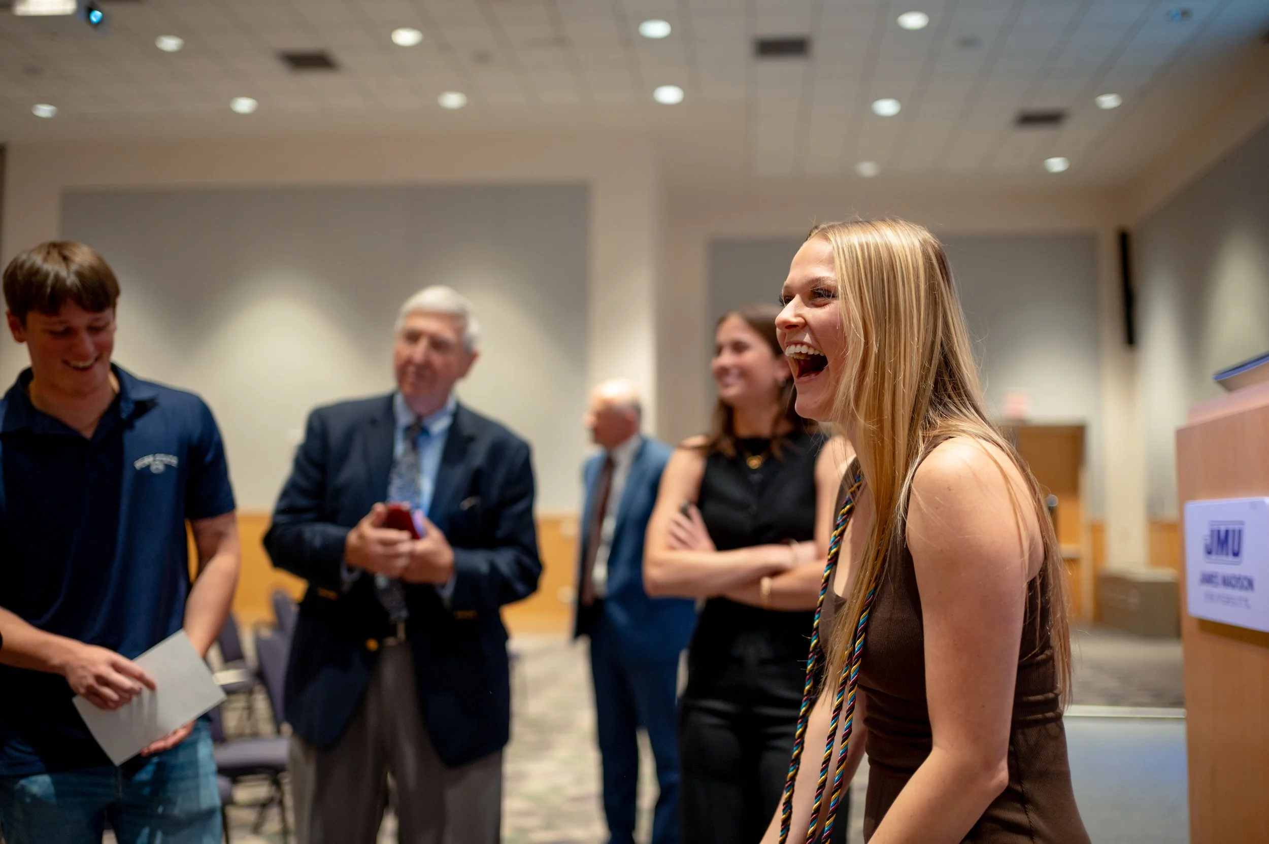  Former Chief White House Producer and Deputy Chief of Staff Grace L. Sawyer takes a moment with her family after being awarded the inaugural Keith B. Jones Award for Excellence in Political Journalism during a surprise ceremony in Harrisonburg, Virg