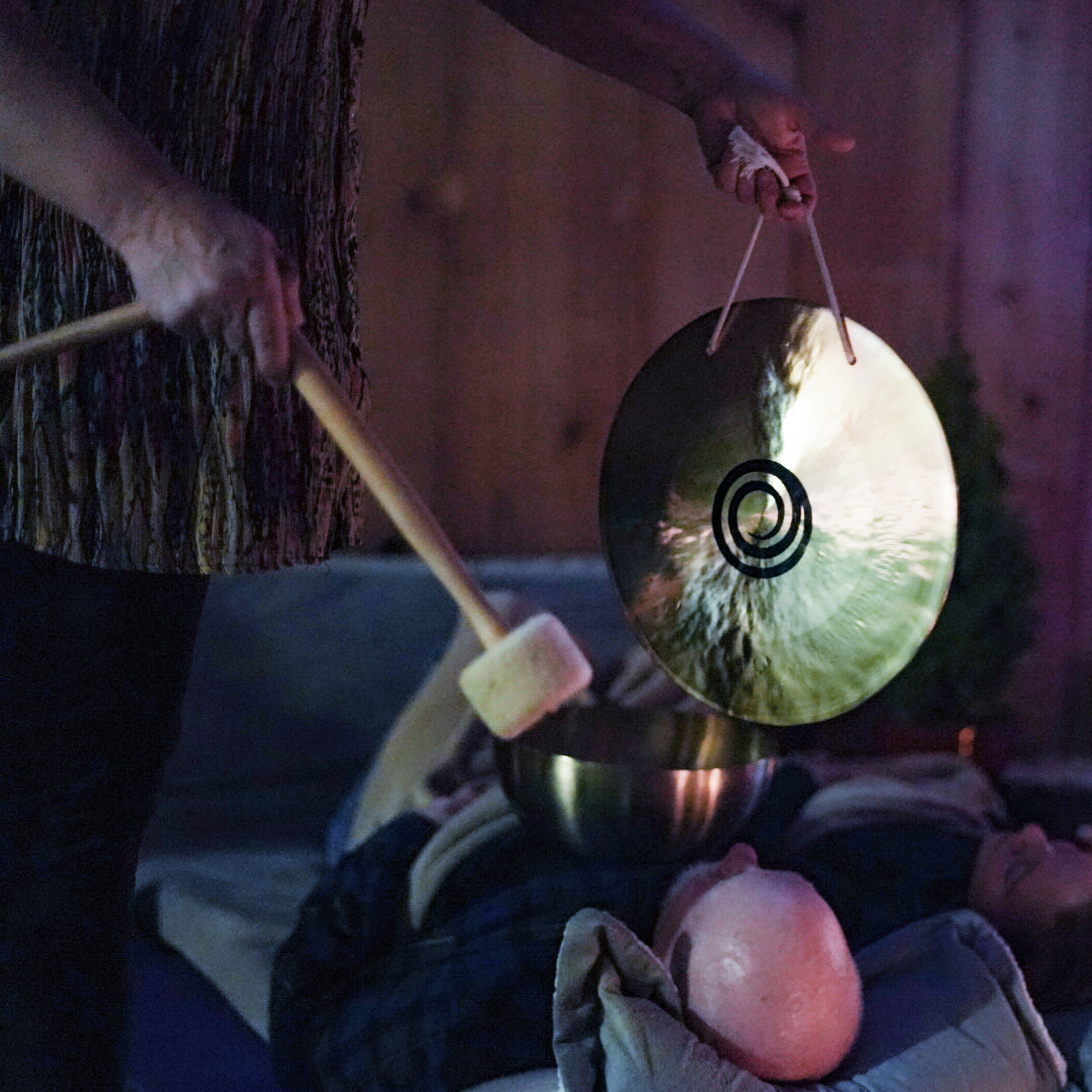  Nadean preforms sound therapy over a member during a ceremony. A hand gong is played above their head to allow negative energy to leave the mind. This helps members clear minds and refocus on their lives.   