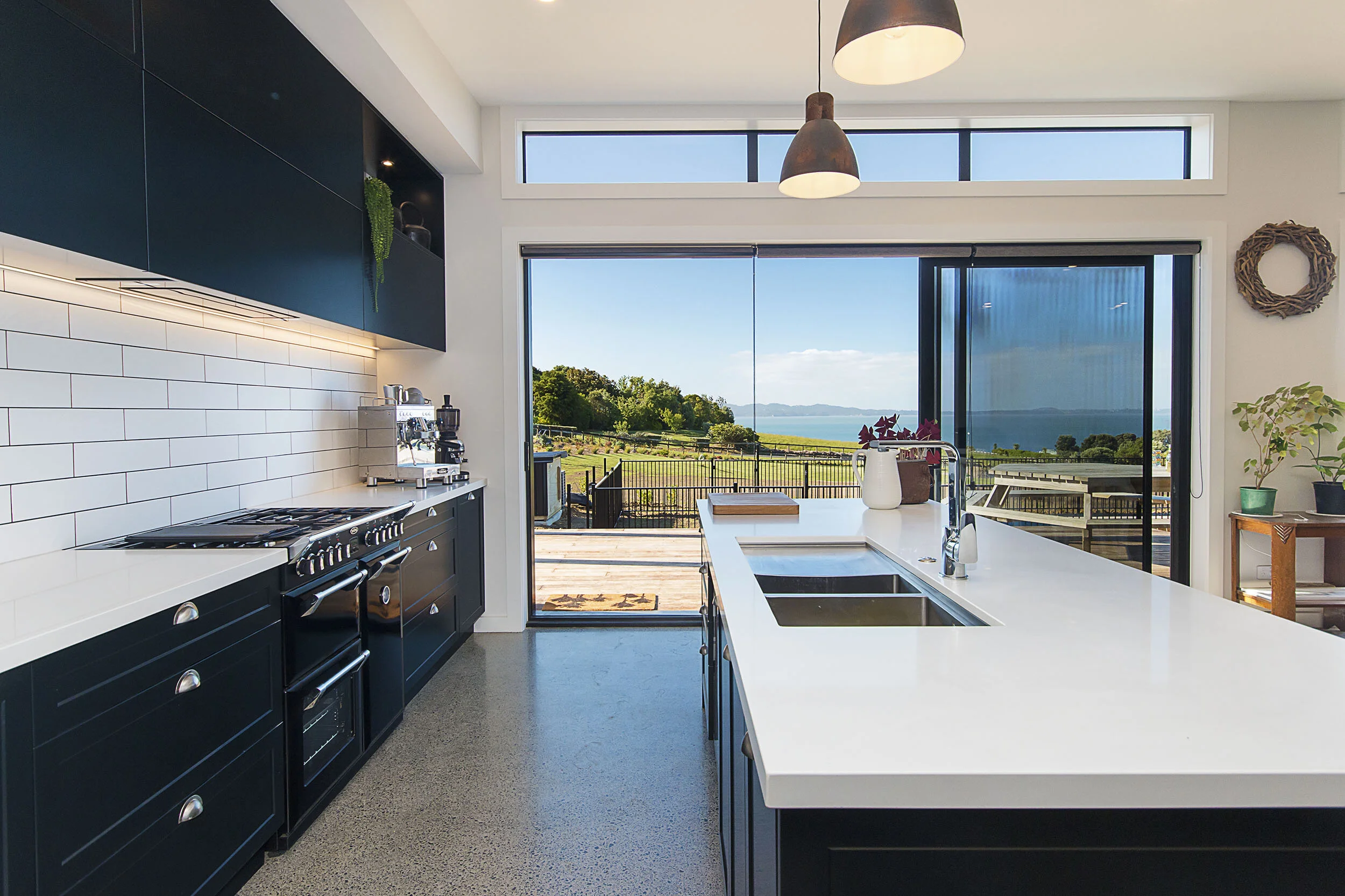 This open plan kitchen takes advantage of the stunning water views. The shaker cabinetry, subway tile and range cooker add to the kitchens character. Great contemporary country kitchen inspiration