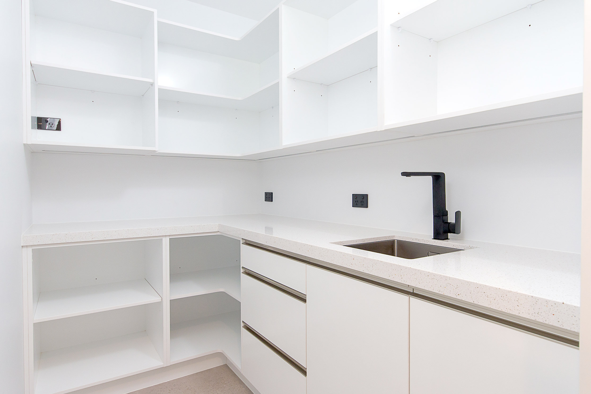 Clean white pantry design with benchtop and sink - Kitchen Dynamics
