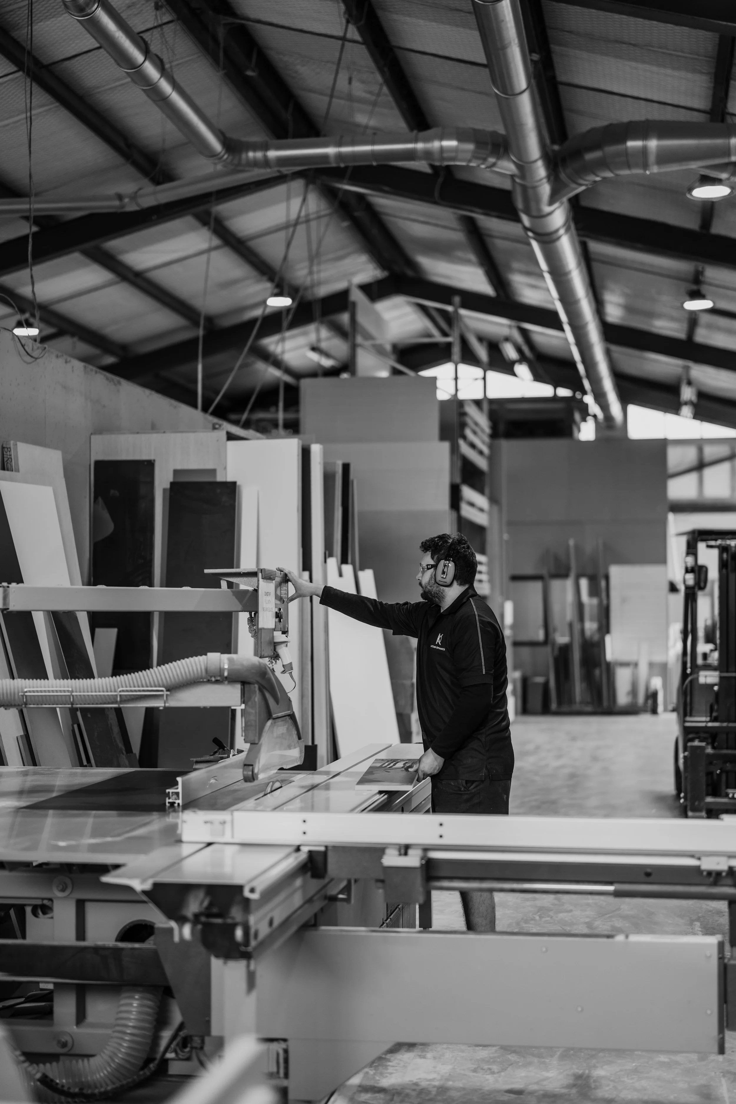 Man in Kitchen Workshop with Saw