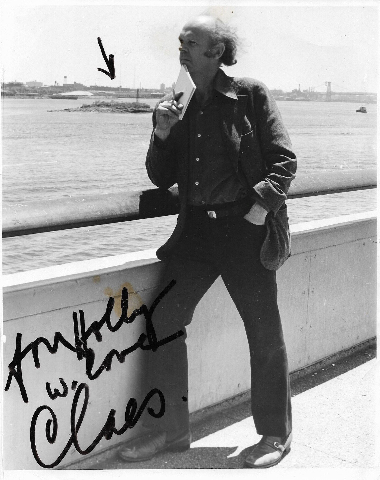 In remembrance of Claes Oldenburg, January 28, 1929 &ndash; July 18, 2022. 

This black &amp; white photograph of Claes, inscribed &quot;for Holly / w. love / Claes.&quot; features a marker-drawn arrow that points to an island in the East River (a so