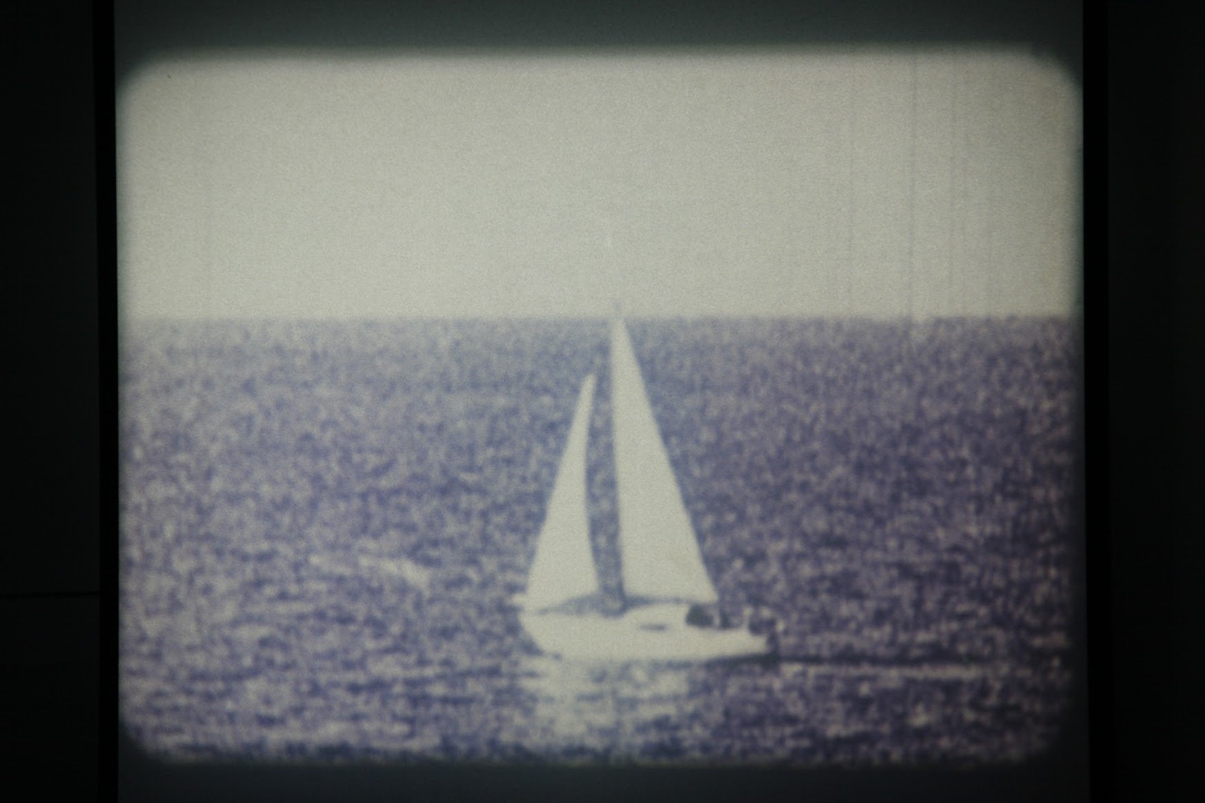  Marcel Broodthaers,  Un Voyage en Mer du Nord  (A Voyage on the North Sea), 1973—1974.   Installation of projected audio-visual recording [16 mm film, colour, silent, 4 min 15s], accompanied by artist's book [offset lithograph printed on double leav