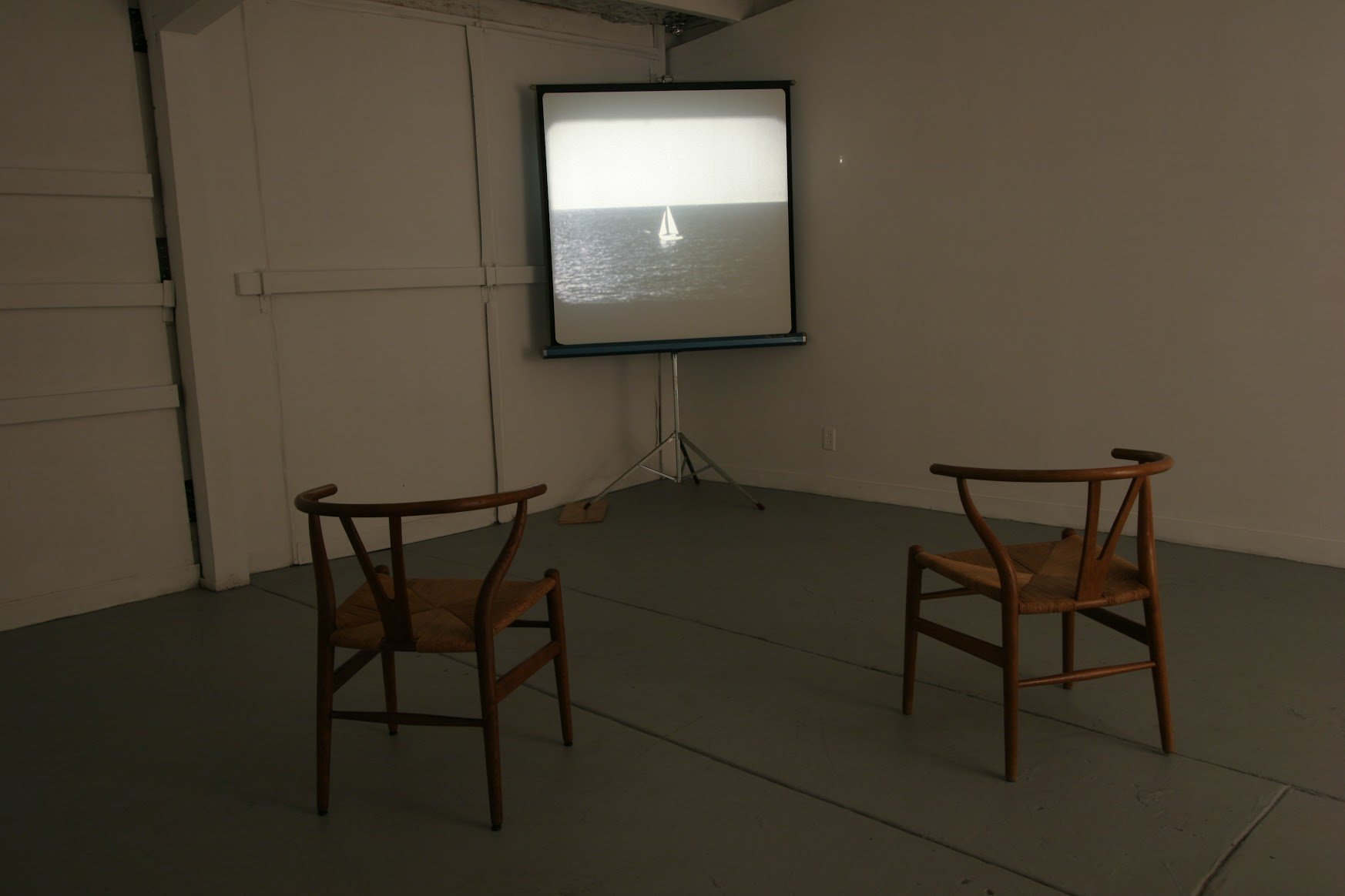  Marcel Broodthaers,  Un Voyage en Mer du Nord  (A Voyage on the North Sea), 1973—1974.   Installation of projected audio-visual recording [16 mm film, colour, silent, 4 min 15s], accompanied by artist's book [offset lithograph printed on double leav